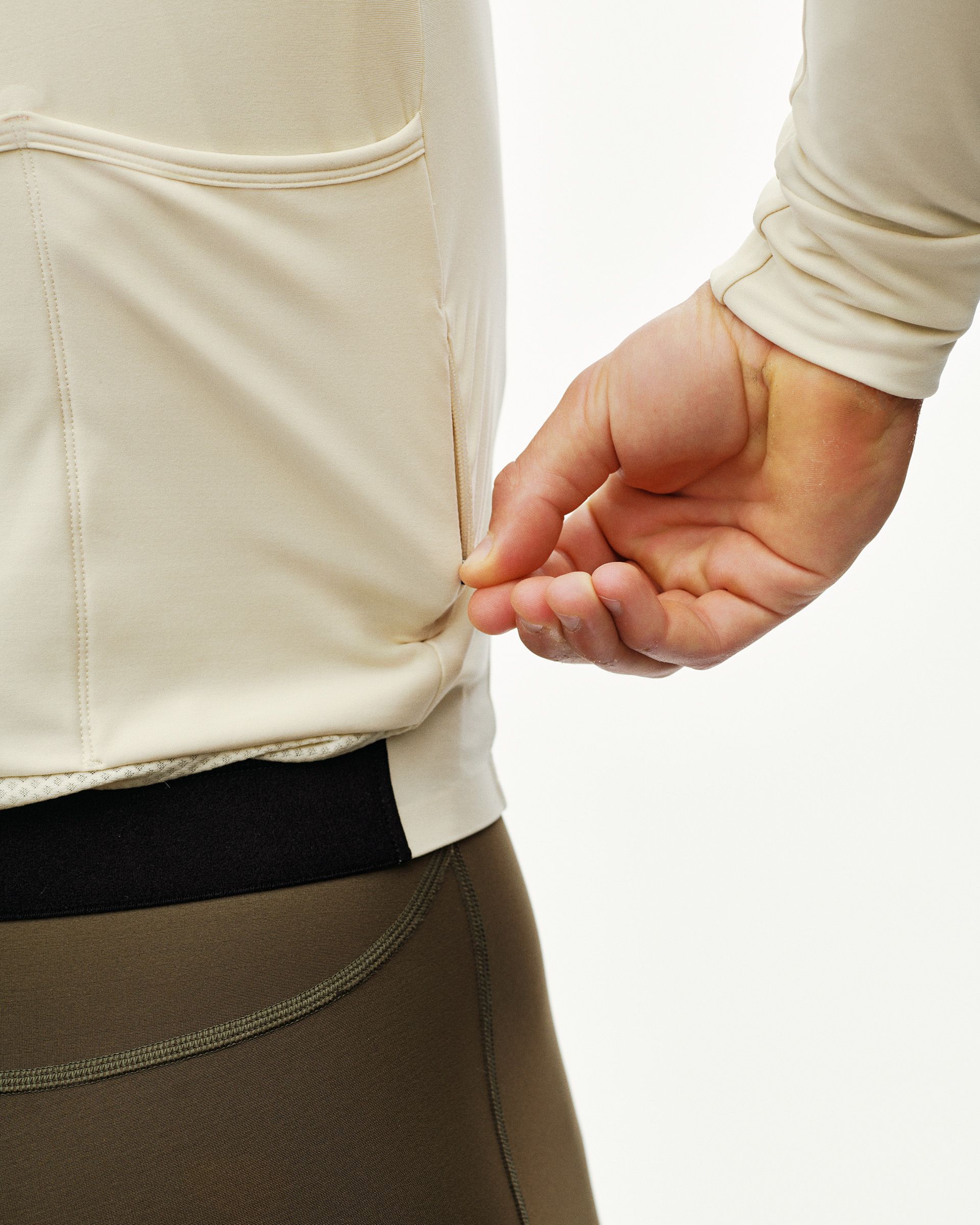 Sand PAS Mechanism long sleeve cycling jersey, rear detail on model showing hem and back pocket panel