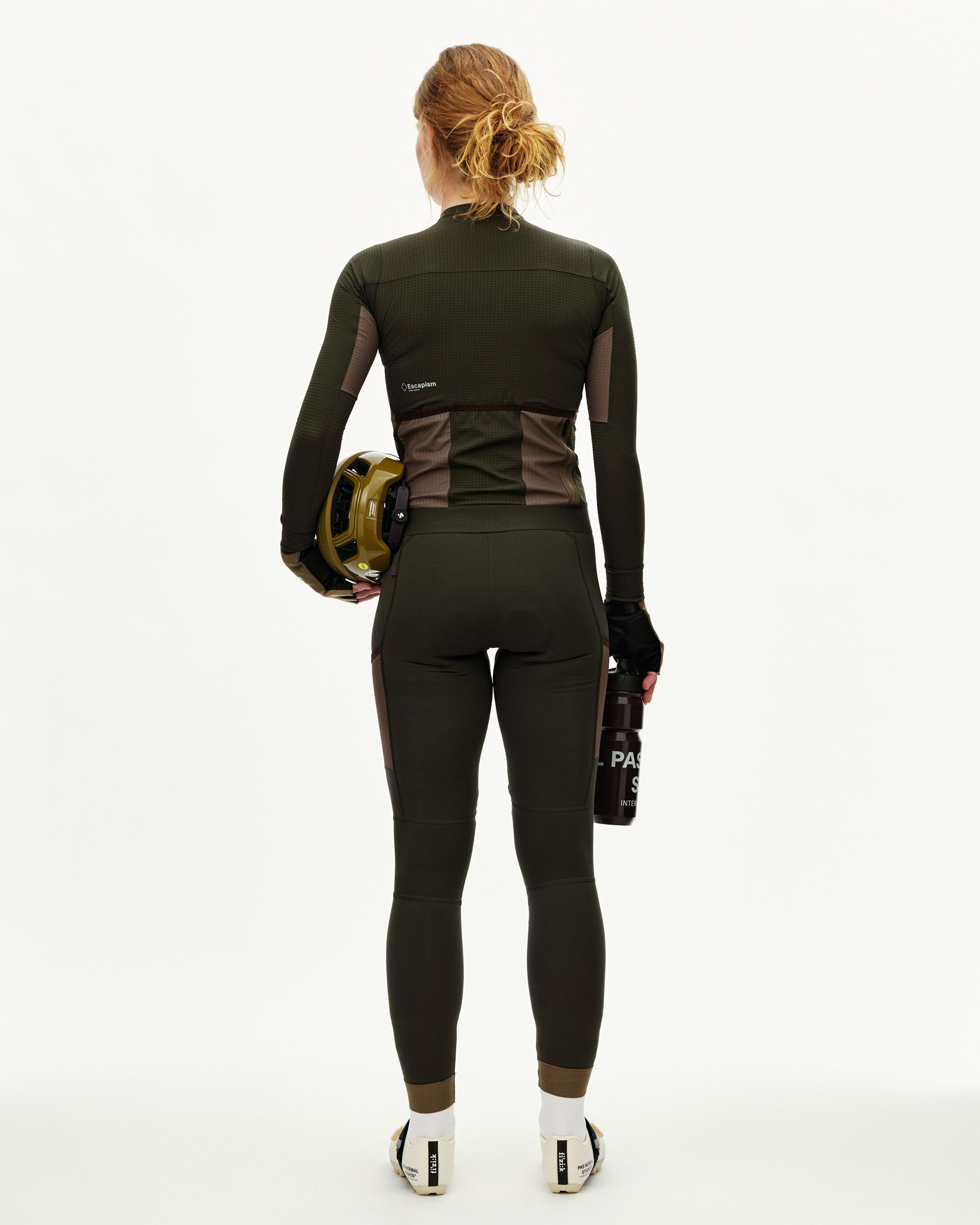 Dark Olive Escapism long sleeve cycling jersey on model, rear view with contrast brown side panels and rear pockets