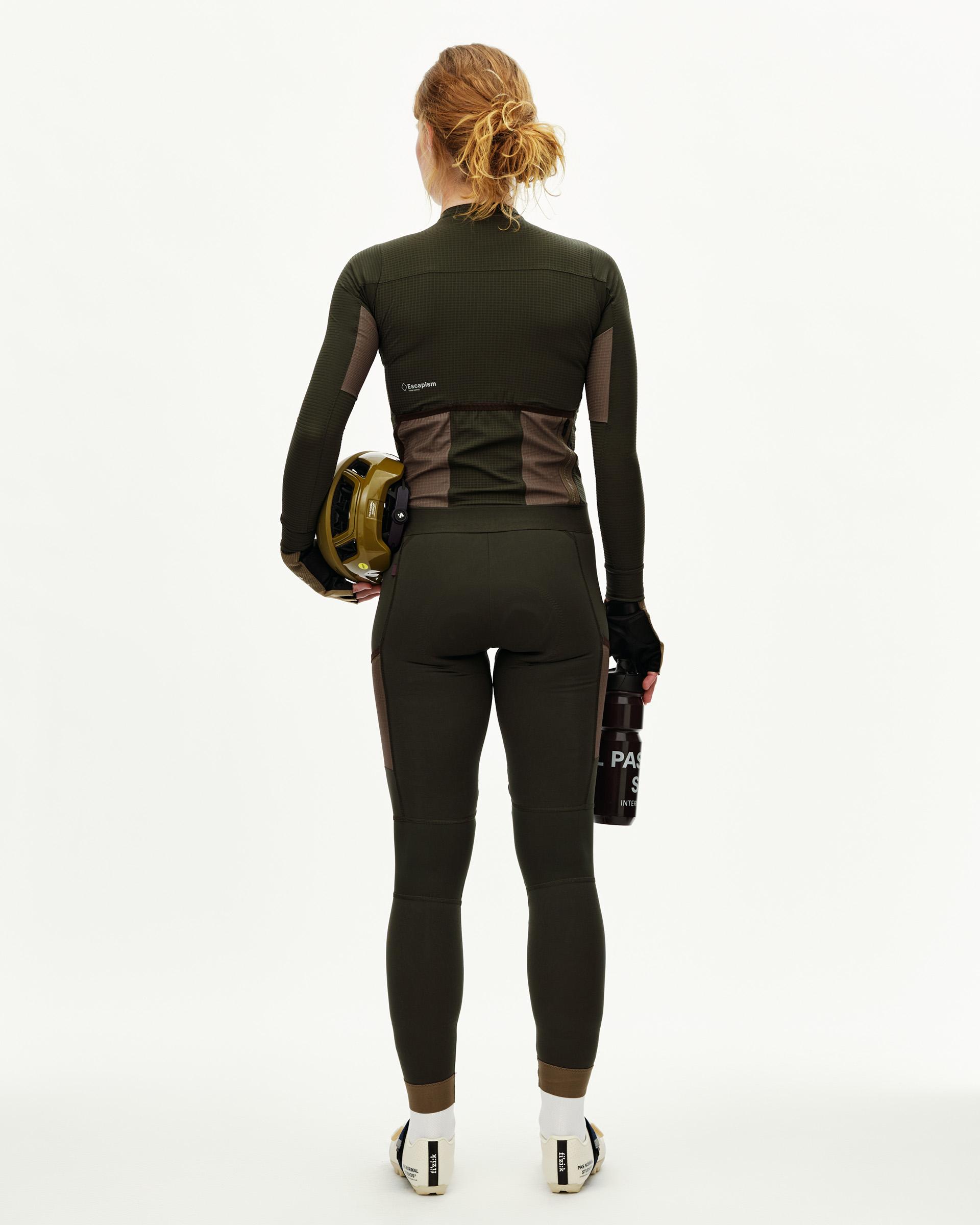 Dark Olive Escapism long sleeve cycling jersey on model, rear view with contrast brown side panels and rear pockets