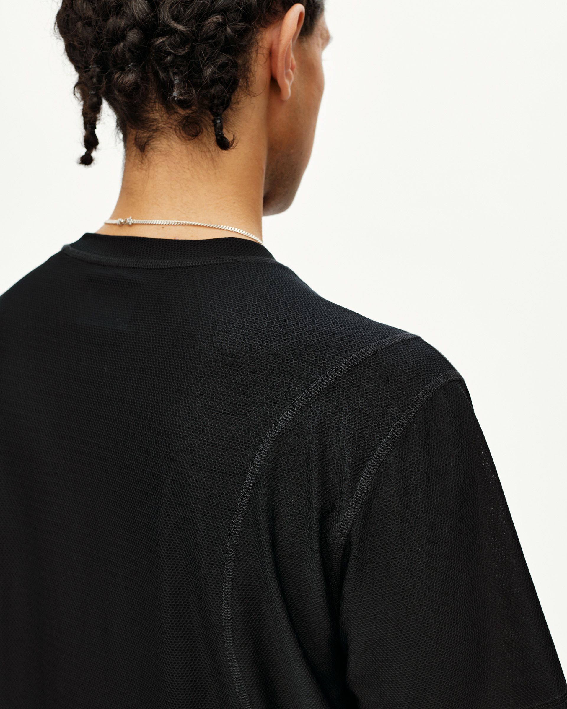 Black Balance T-shirt on model, rear detail view with mesh texture and contrast seams