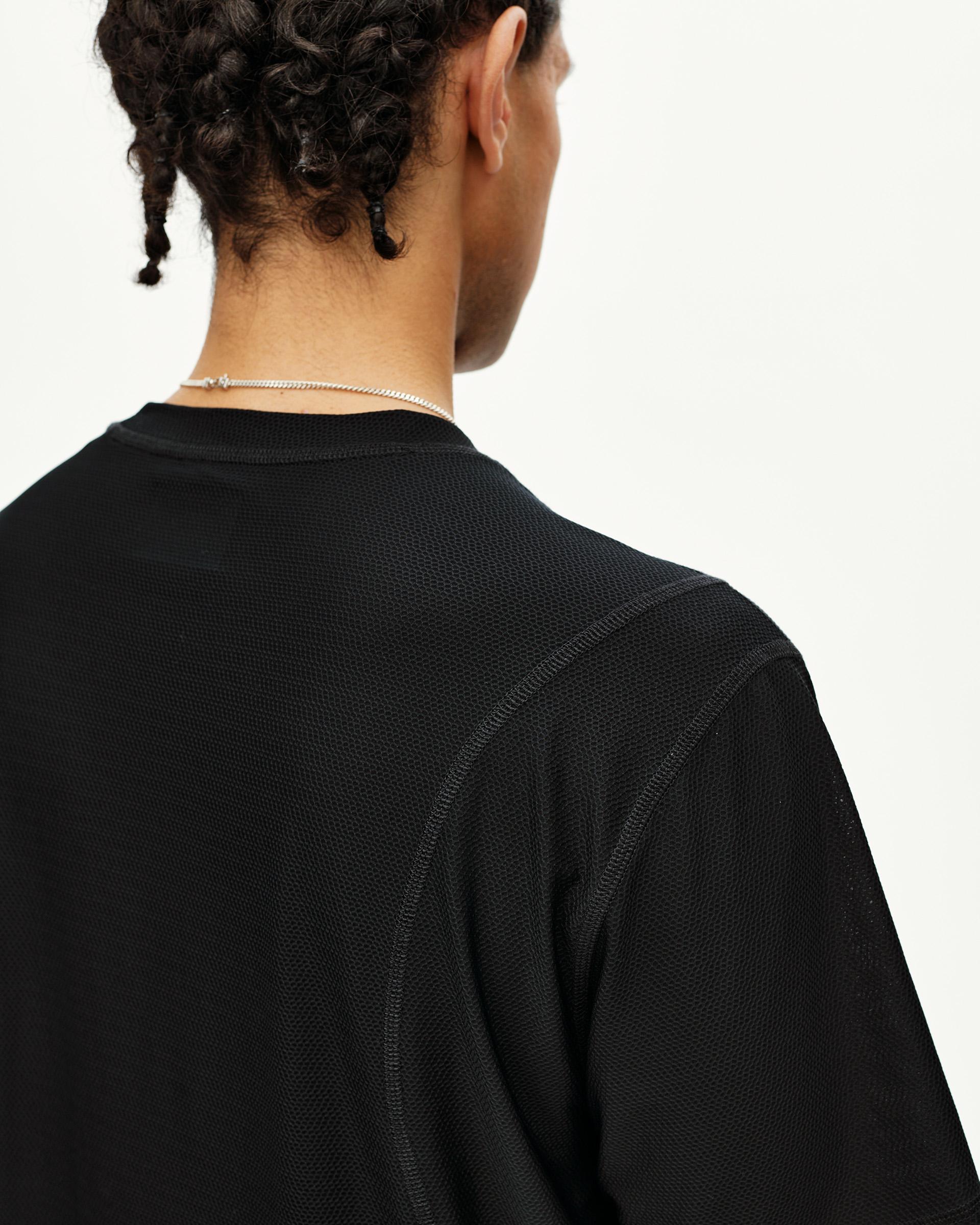 Black Balance T-shirt on model, rear detail view with mesh texture and contrast seams