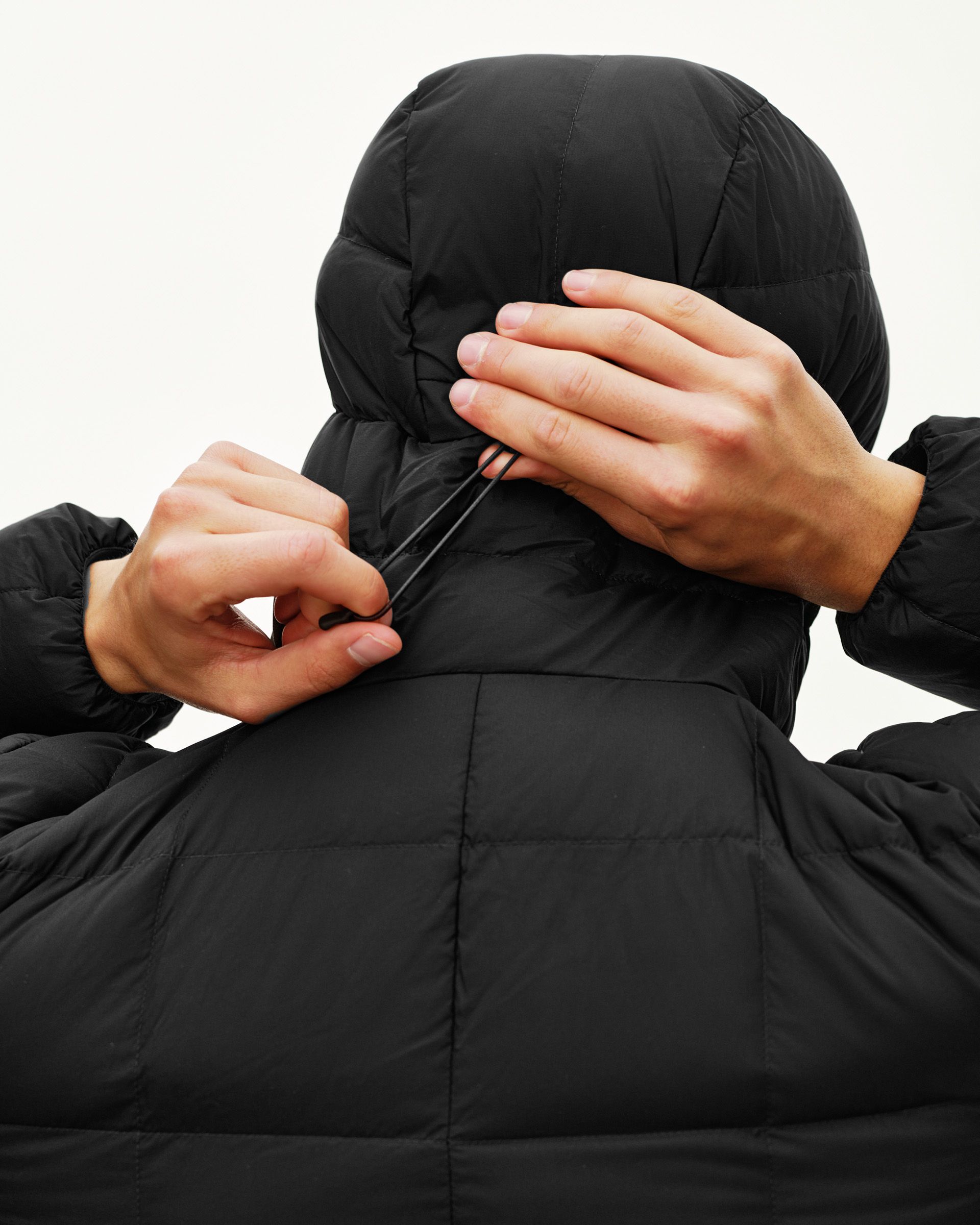 Black Off-Race Down Liner jacket, rear detail on model showing hood drawcord adjustment