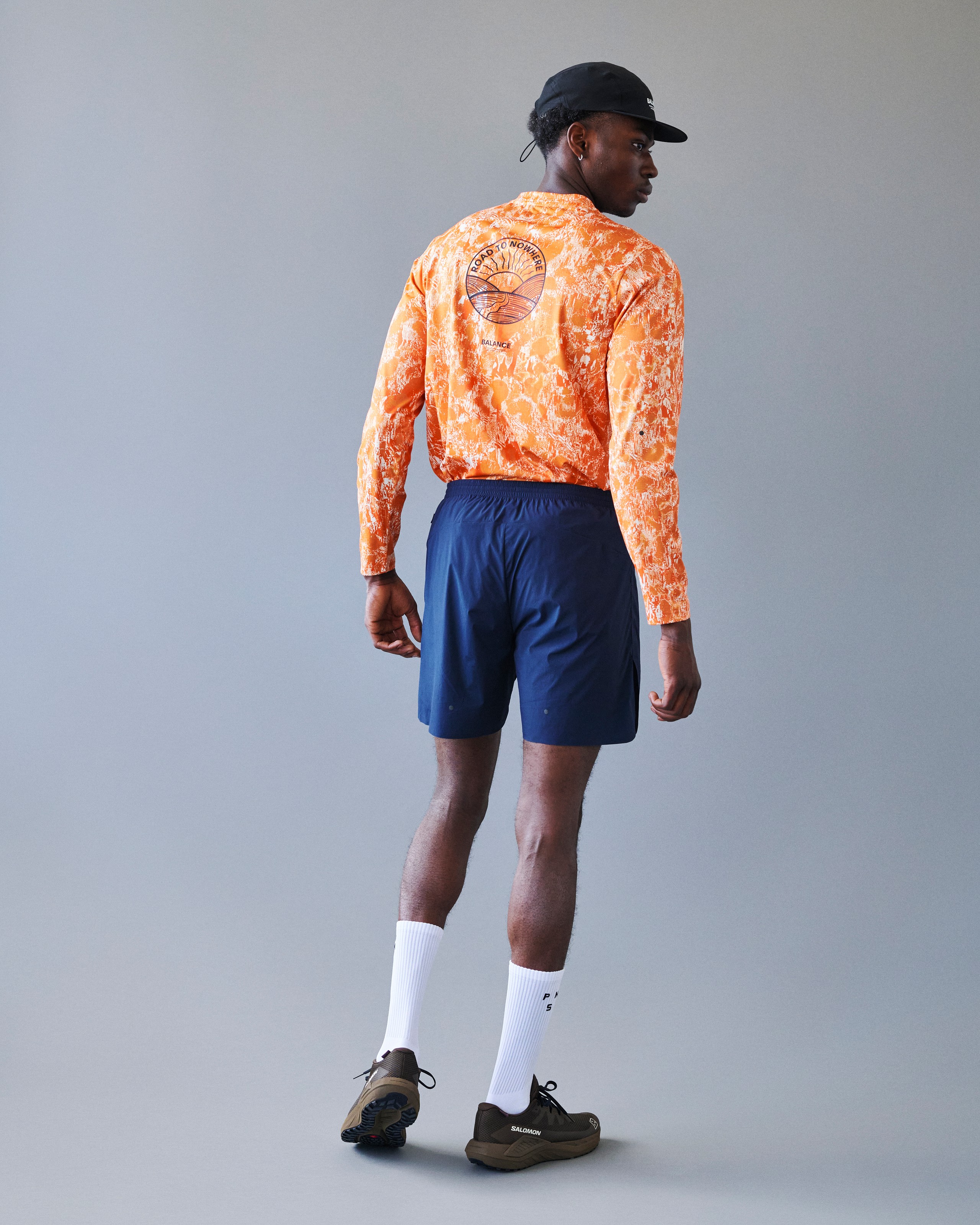 Orange Balance long sleeve t-shirt on model, rear view with circular back print