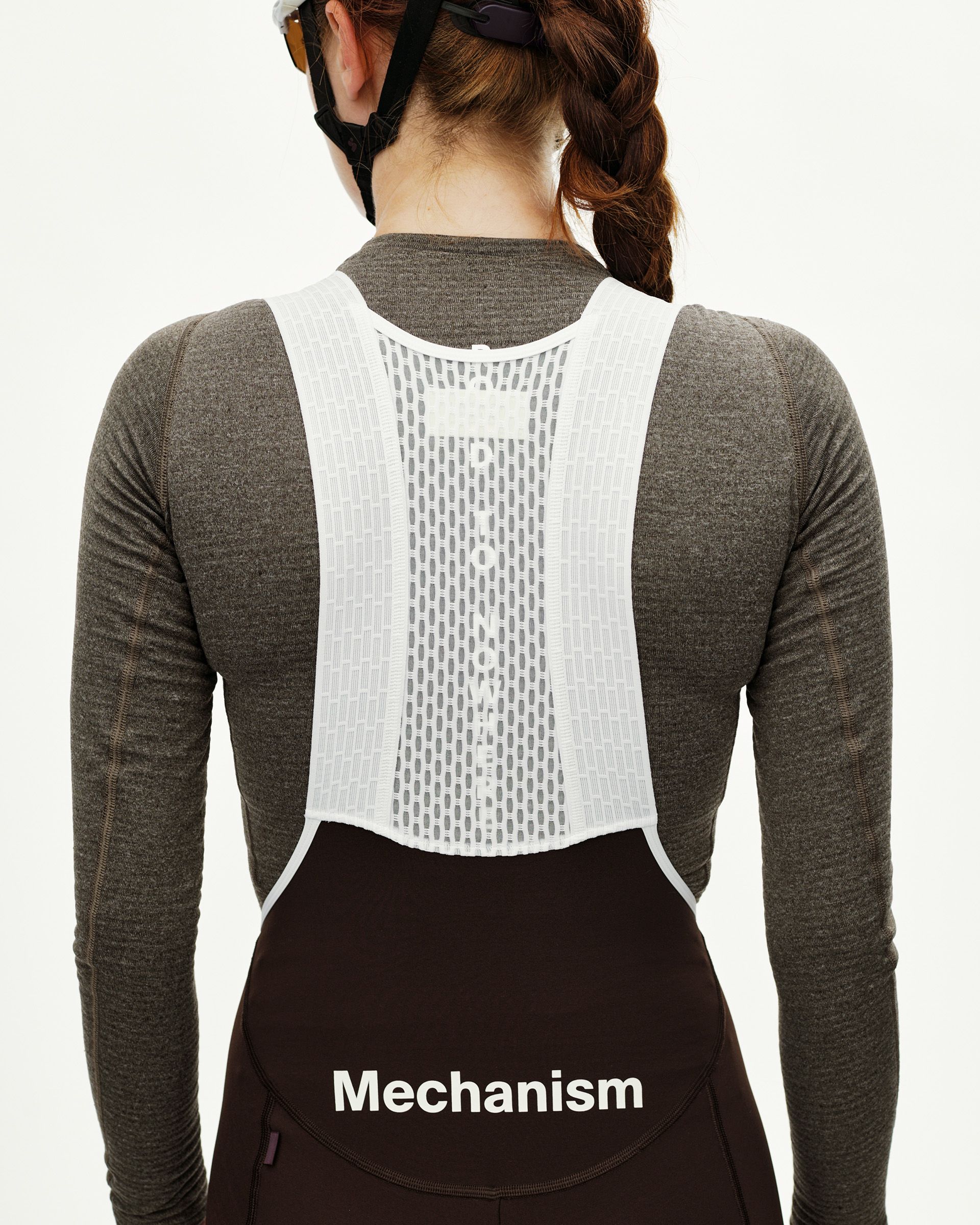 Dark Coffee Mechanism Thermal Long cycling bibs on model, rear view with white mesh bib straps and logo print