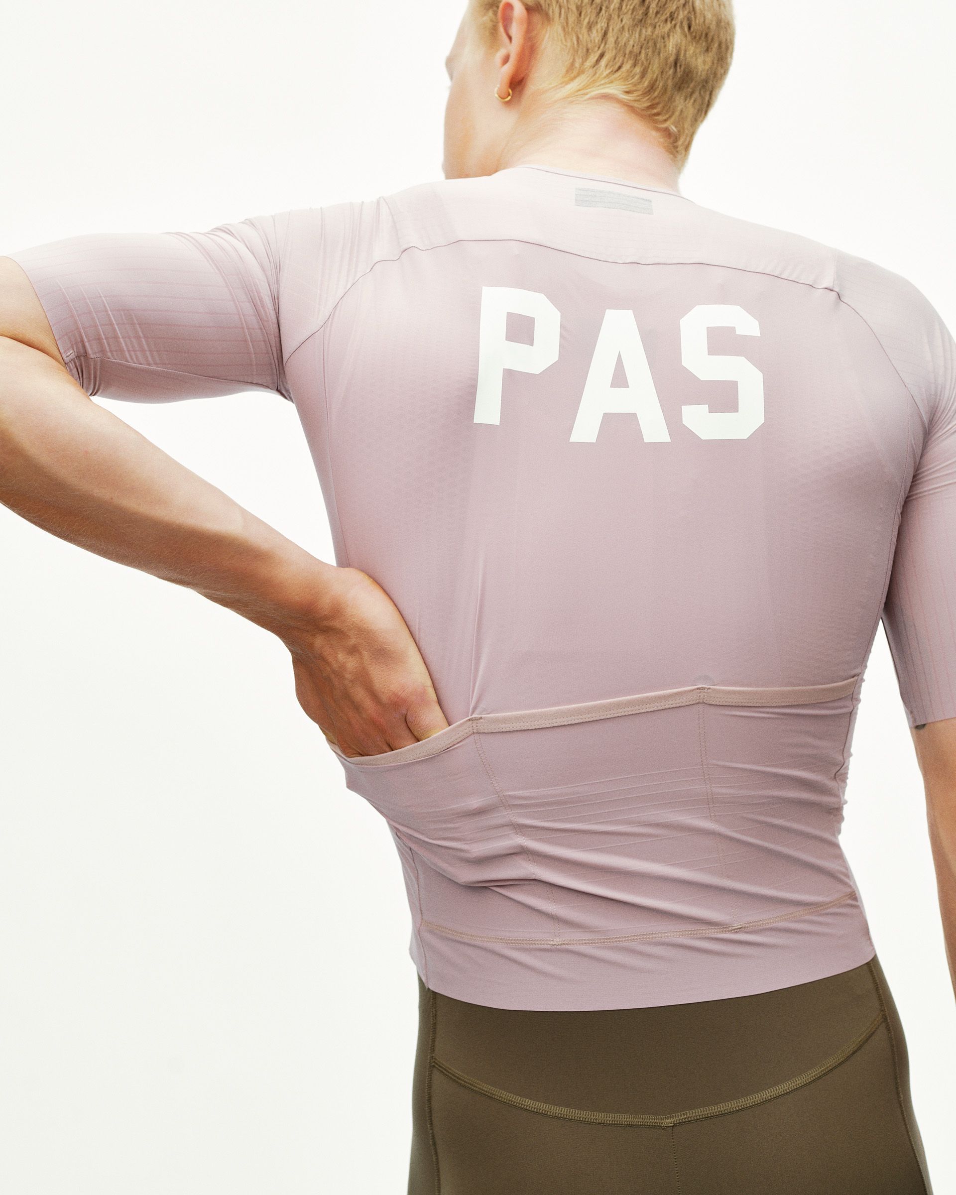 Taupe Rose PAS Mechanism Pro cycling jersey on model, rear view with white PAS back print and rear pockets