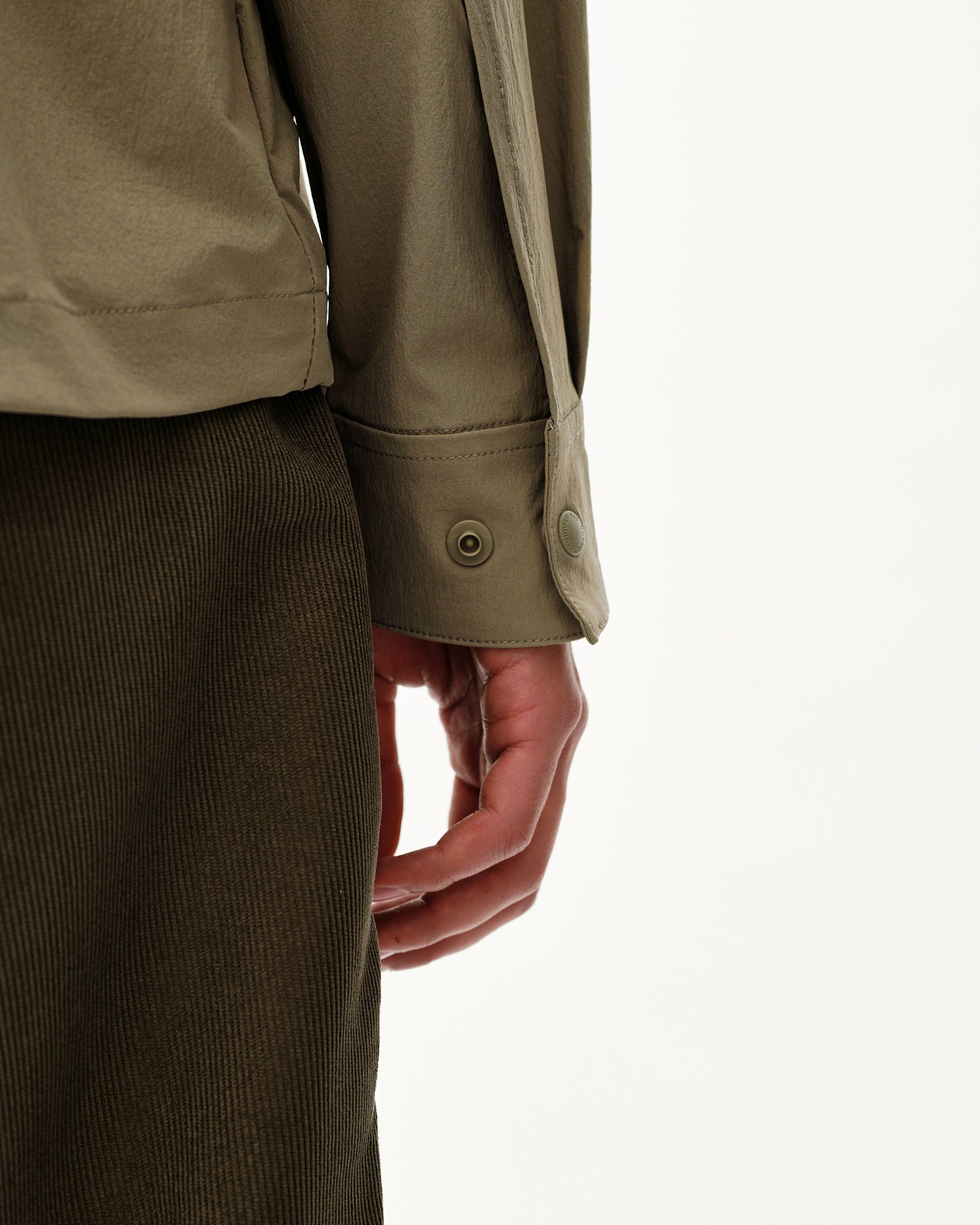 Dusty Earth khaki Off-Race Tech Overshirt, side detail on model showing snap-button cuff