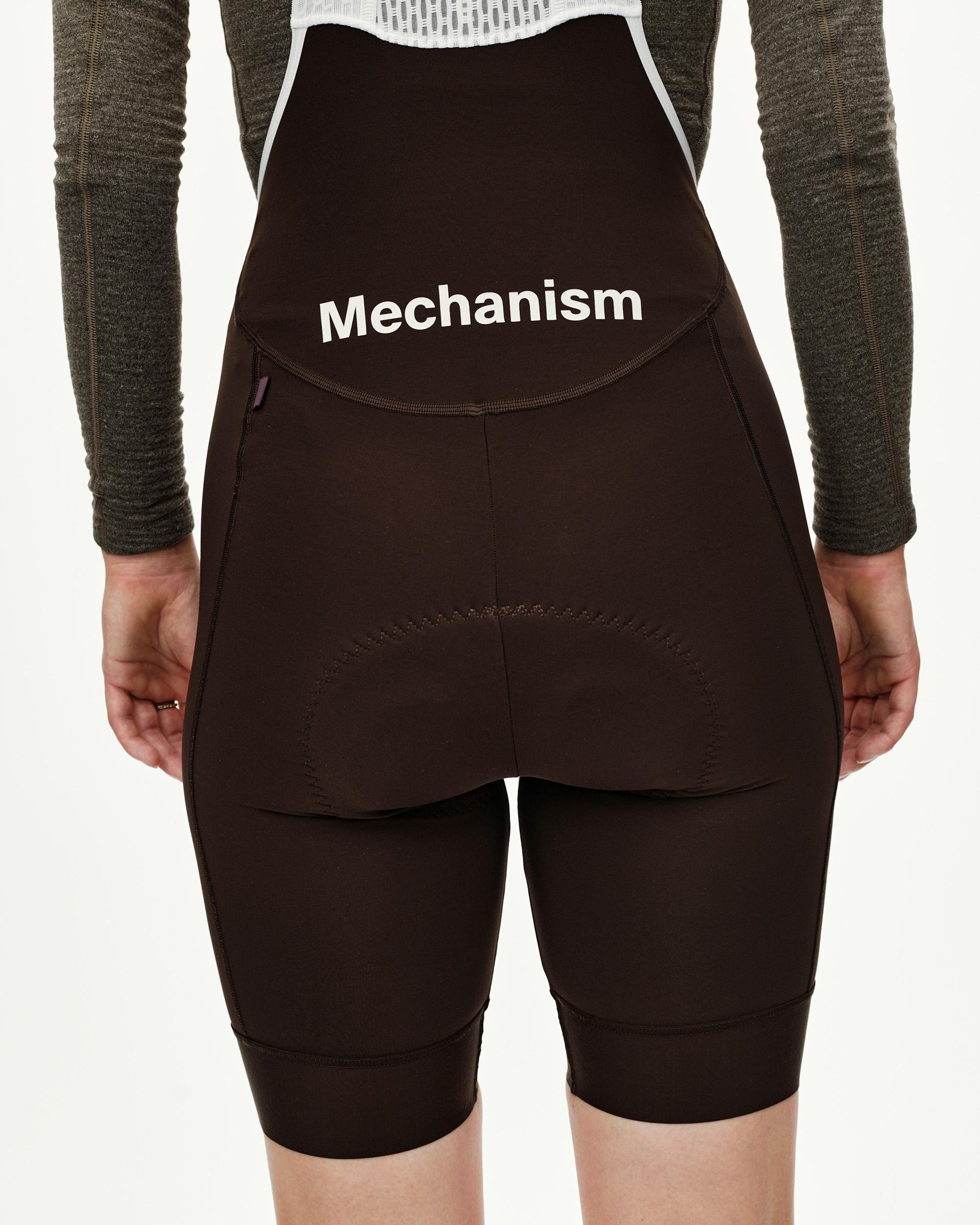 Dark Coffee Mechanism Thermal cycling bibs on model, rear view with white logo print on bib panel