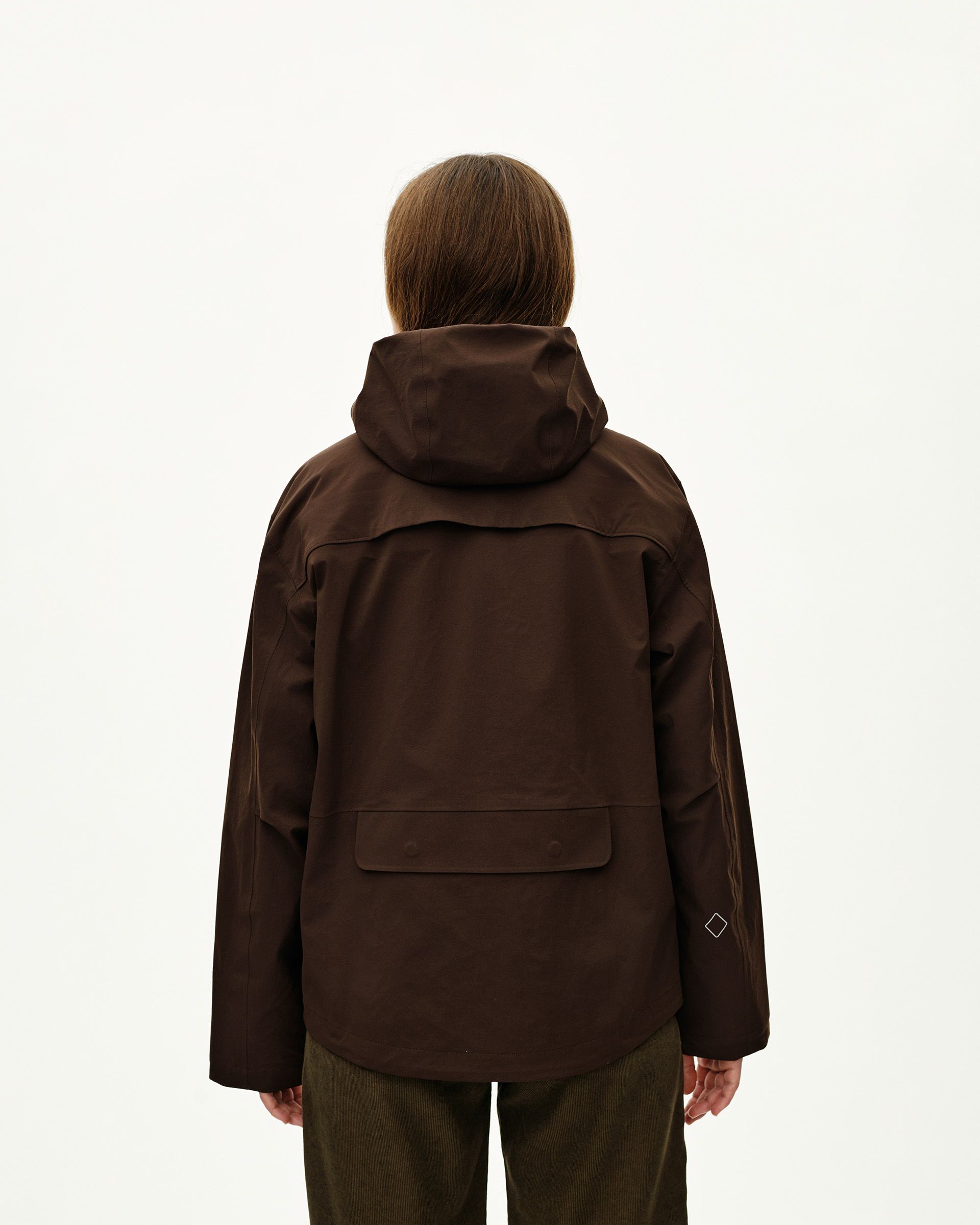 Dark Coffee brown Off-Race 3L Shell jacket on model, rear view with storm hood and back pocket flap