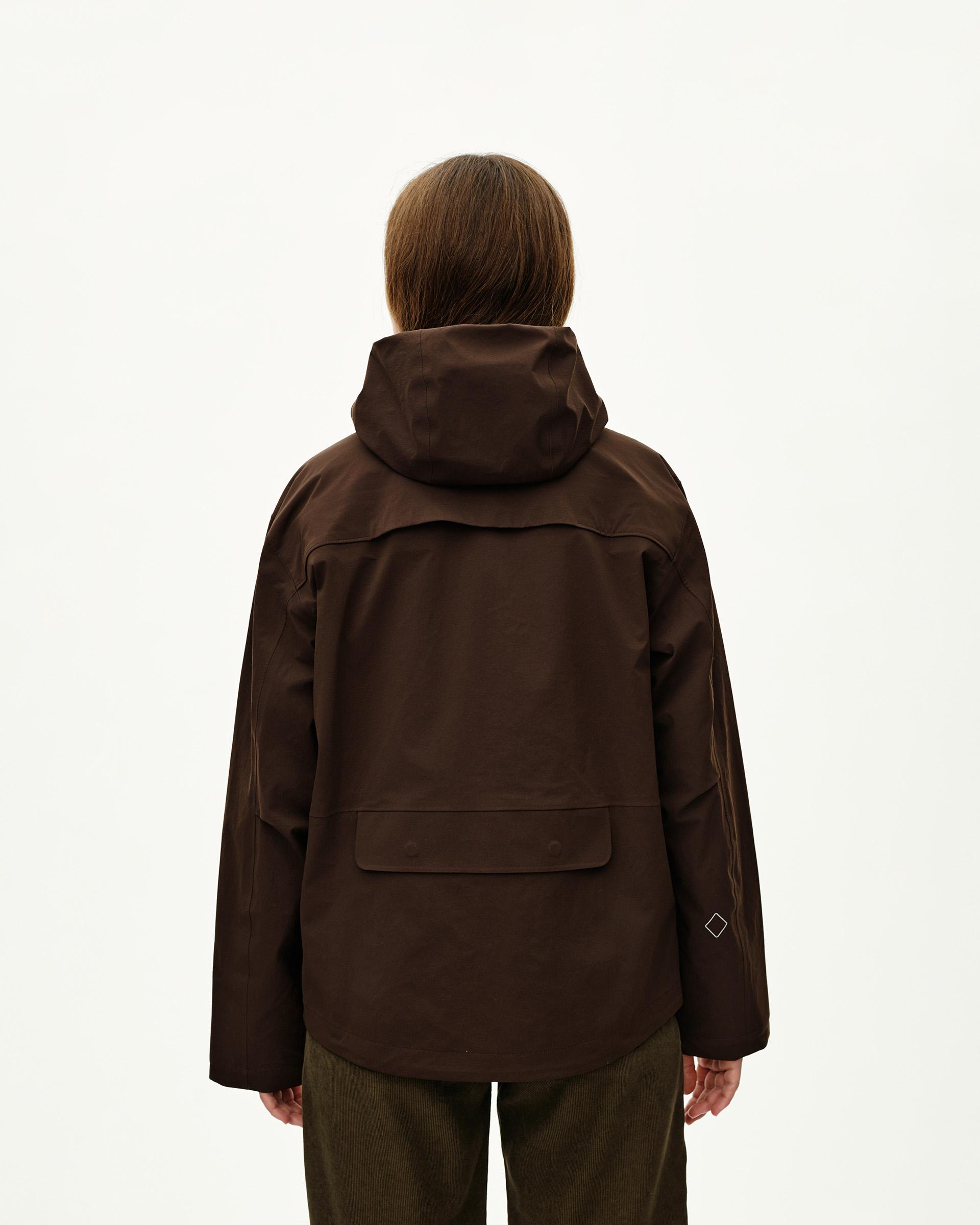 Dark Coffee brown Off-Race 3L Shell jacket on model, rear view with storm hood and back pocket flap