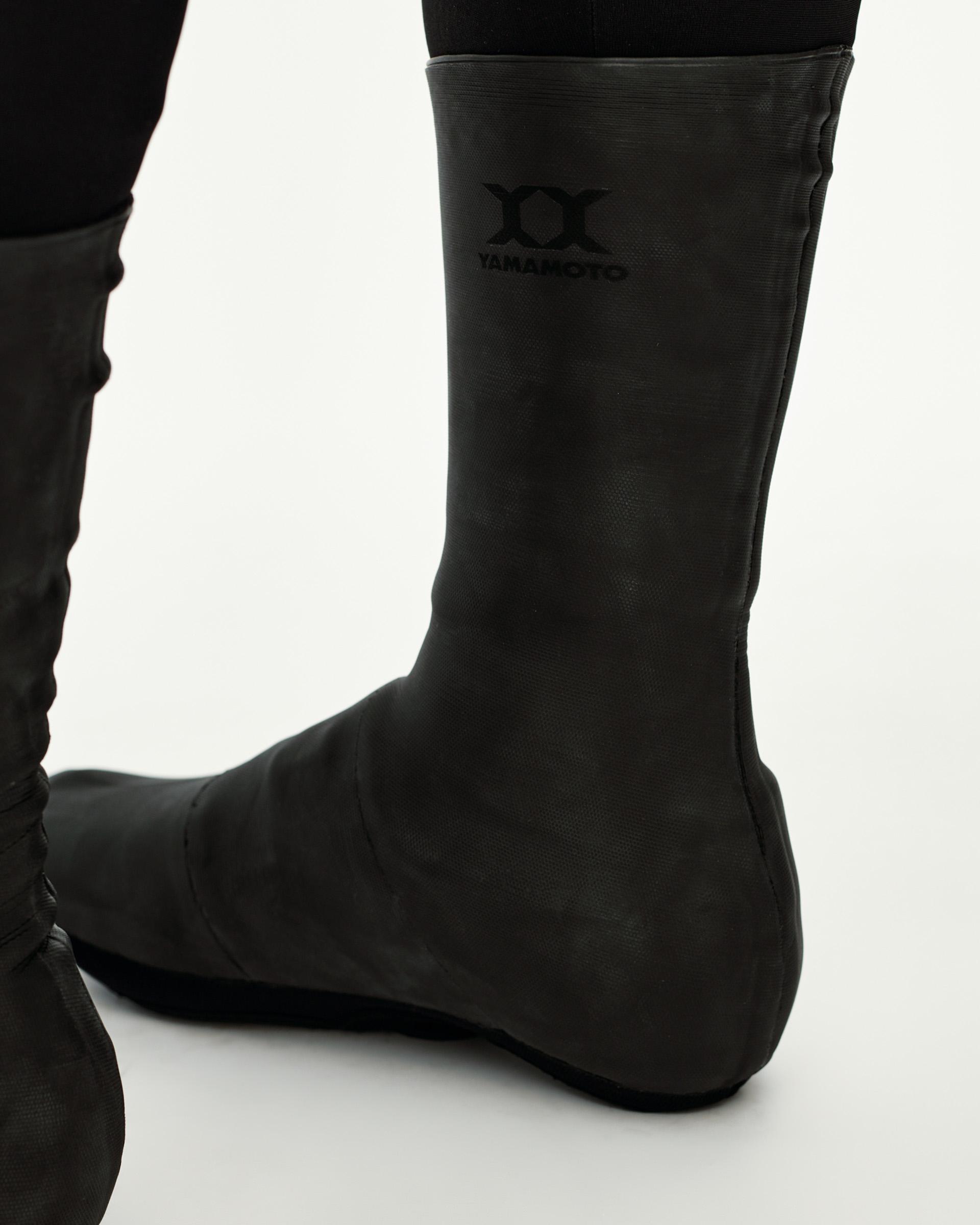 Black Logo Heavy cycling overshoes, side detail on model with Yamamoto chest logo print