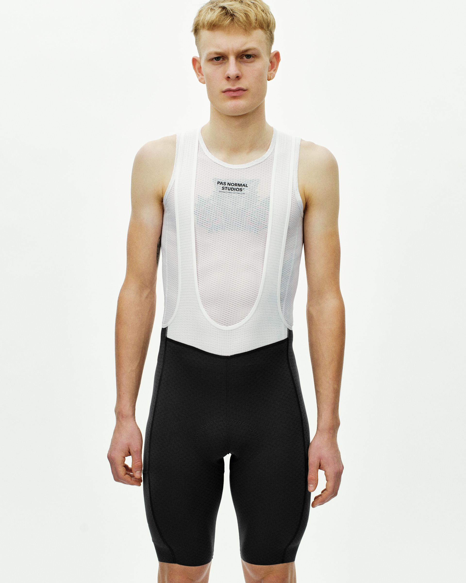 Black Essential Light Cargo cycling bibs on model with white mesh bib straps