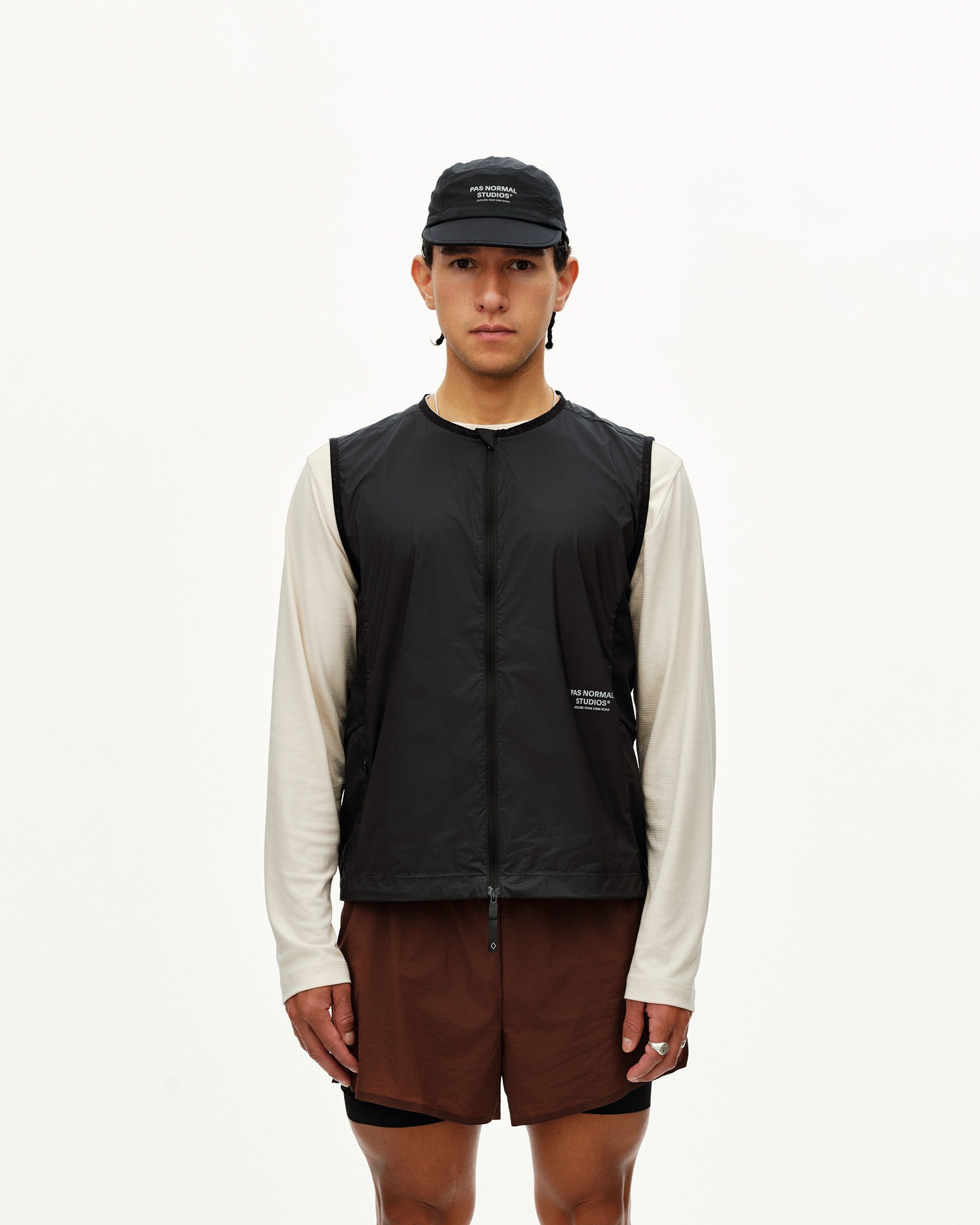 Black Balance Windproof vest on model, front view with center zip and small chest logo print