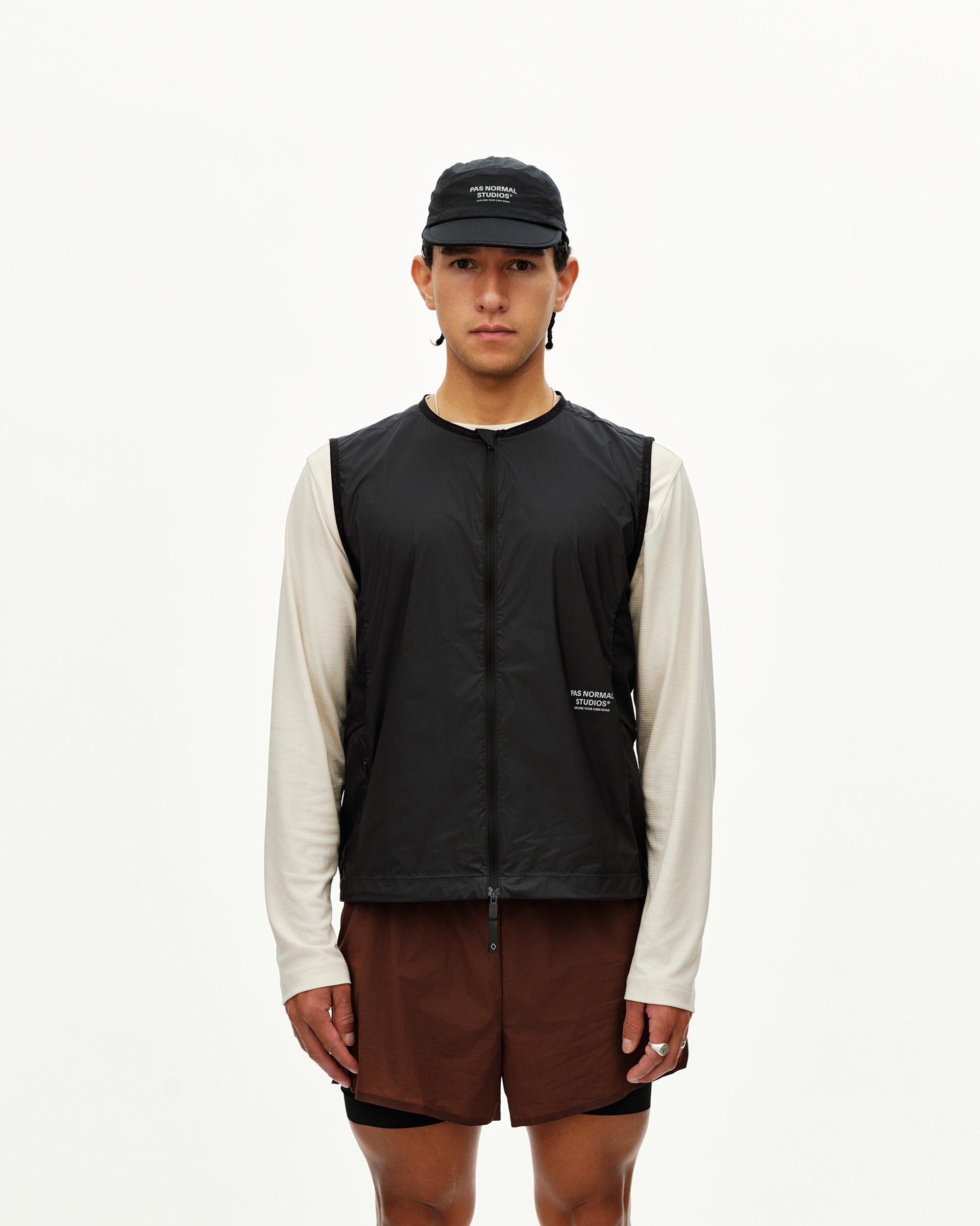 Black Balance Windproof vest on model, front view with center zip and small chest logo print