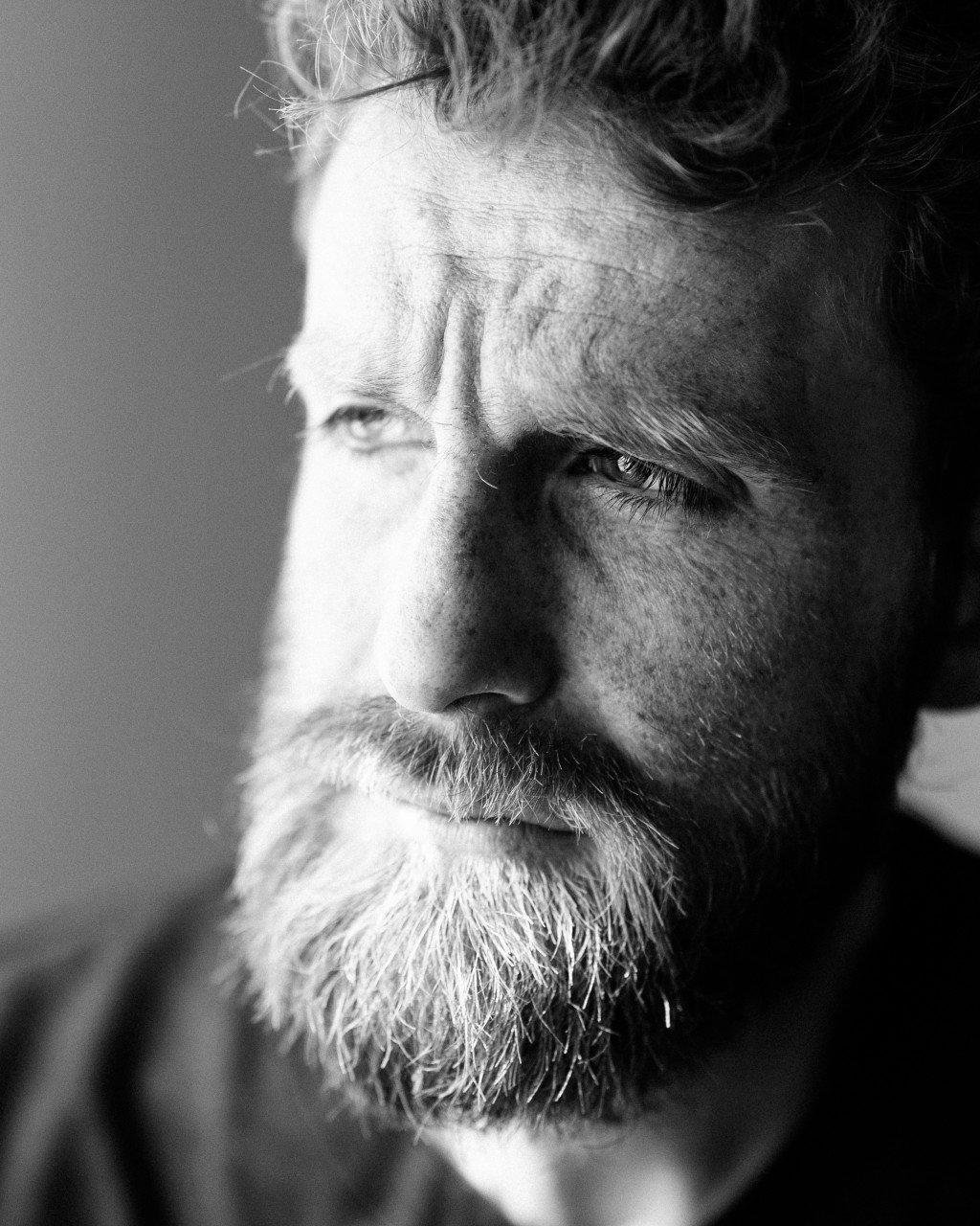 Close-up black and white portrait of bearded cyclist Mattia De Marchi