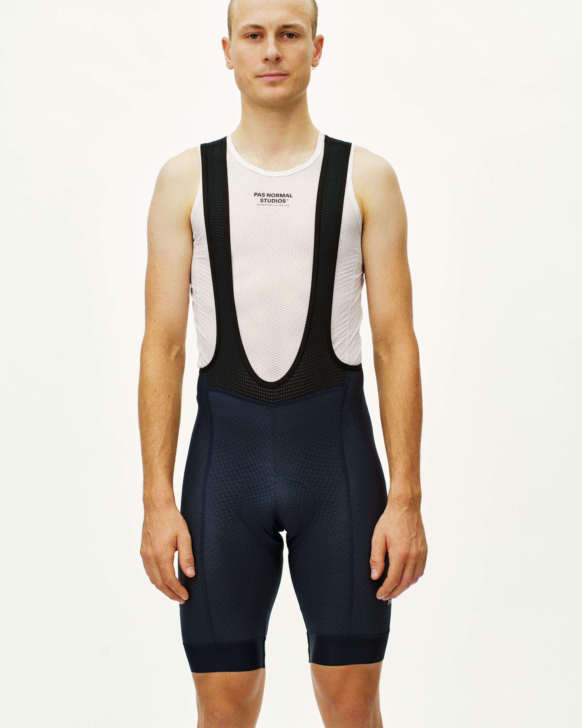 Navy Essential cycling bibs on model, front view with black mesh bib straps