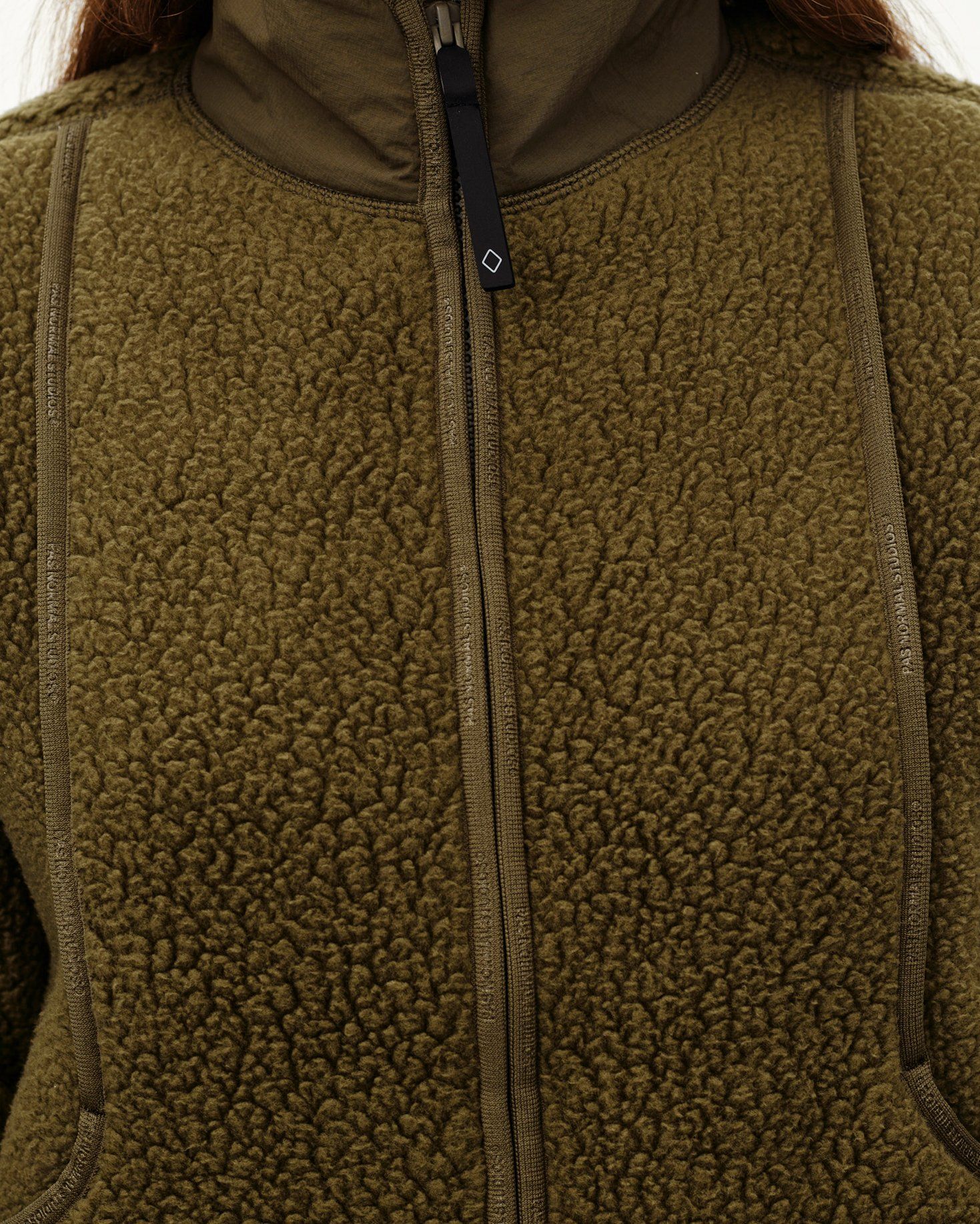Army Green Off-Race Pile Fleece jacket, detail view on model with branded seam tape and center zip