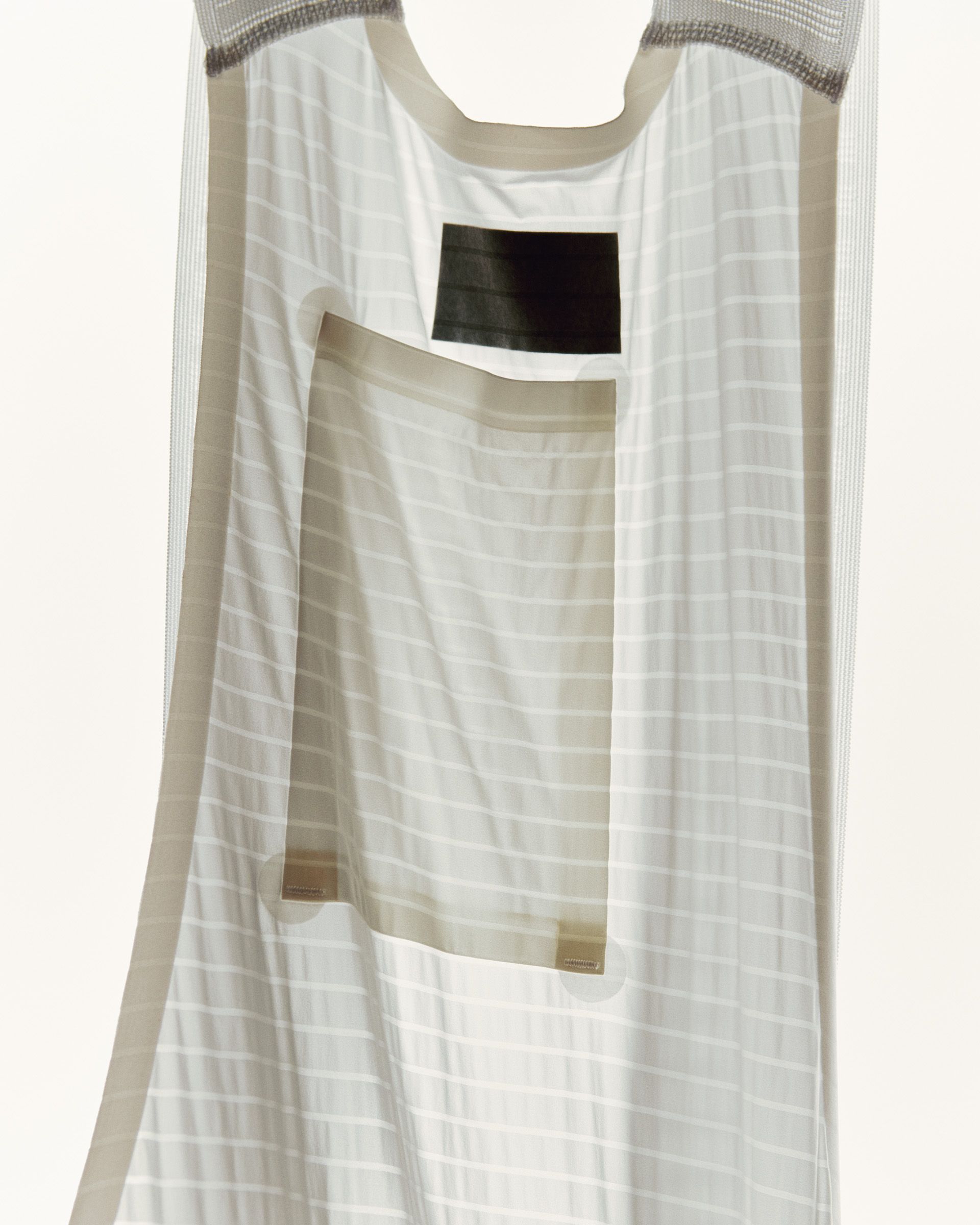 Men's Mechanism Pro Base Layer in white with textured grid pattern and rear pocket detail
