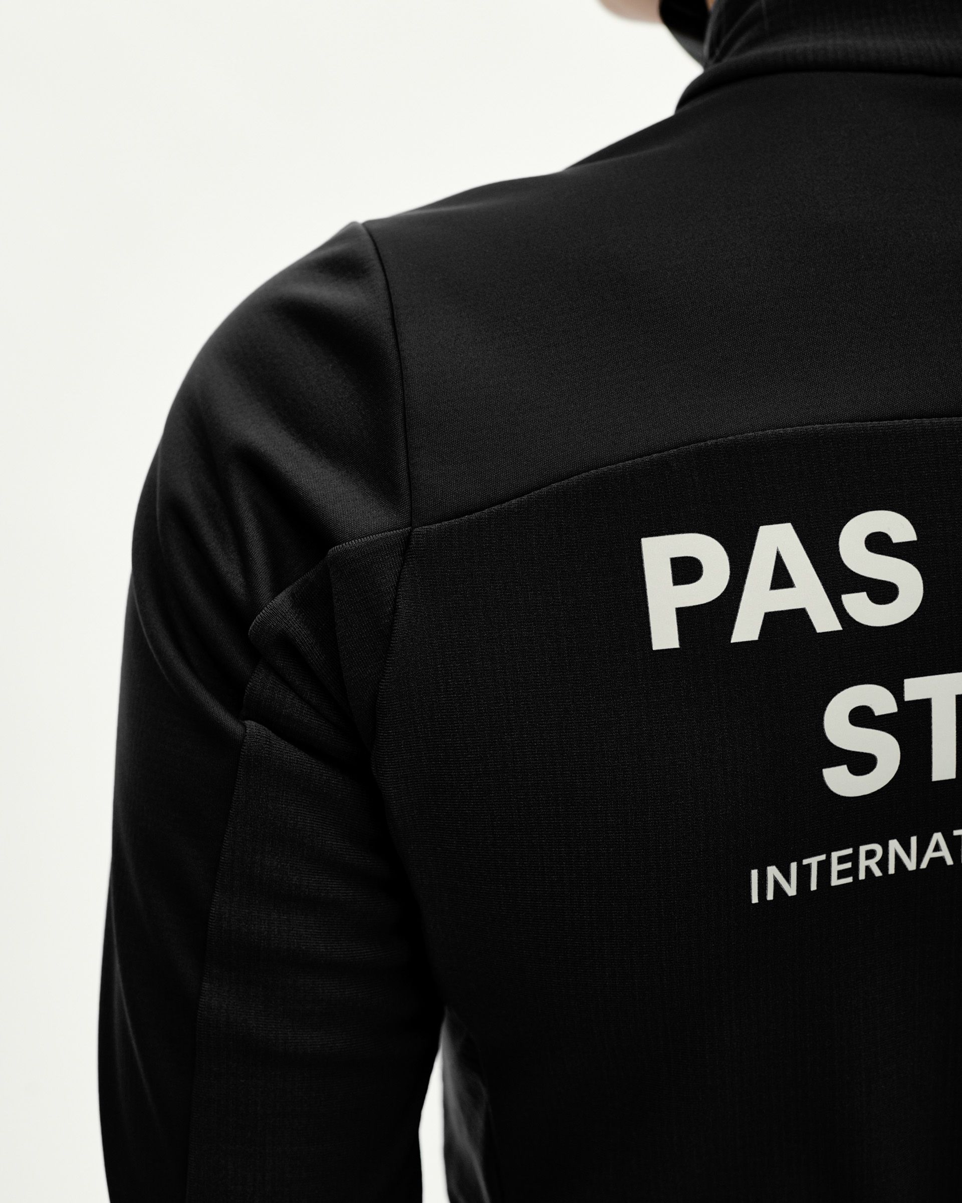 Black Mechanism Thermal Long Sleeve cycling jersey, rear detail on model with white back print