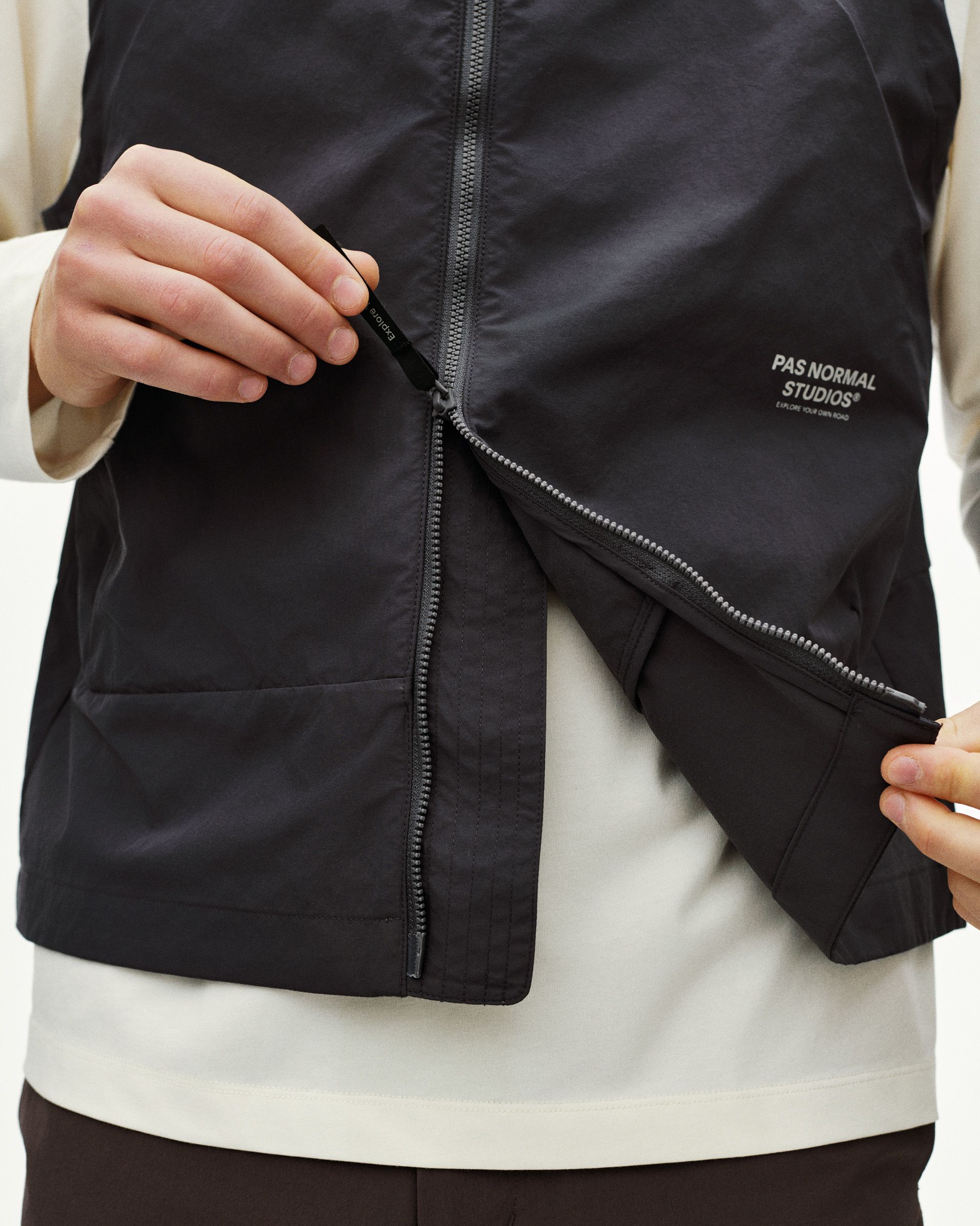 Black Off-Race Utility vest on model showing zippered chest pocket and side zip detail