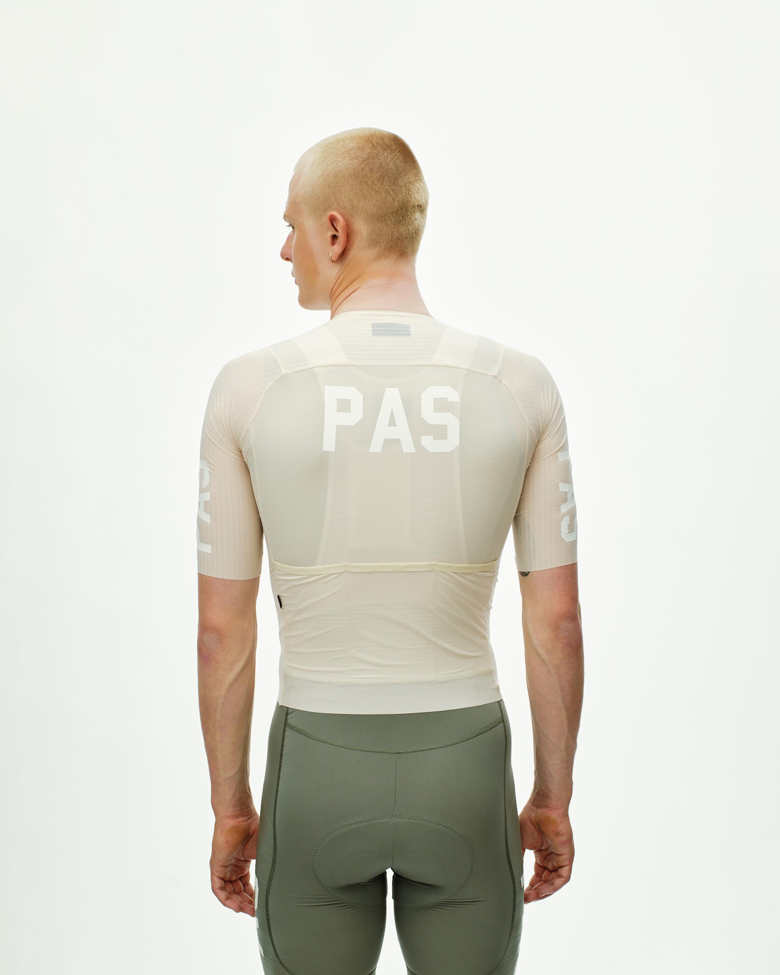 Cream PAS Mechanism Pro cycling jersey on model, rear view with white PAS back print