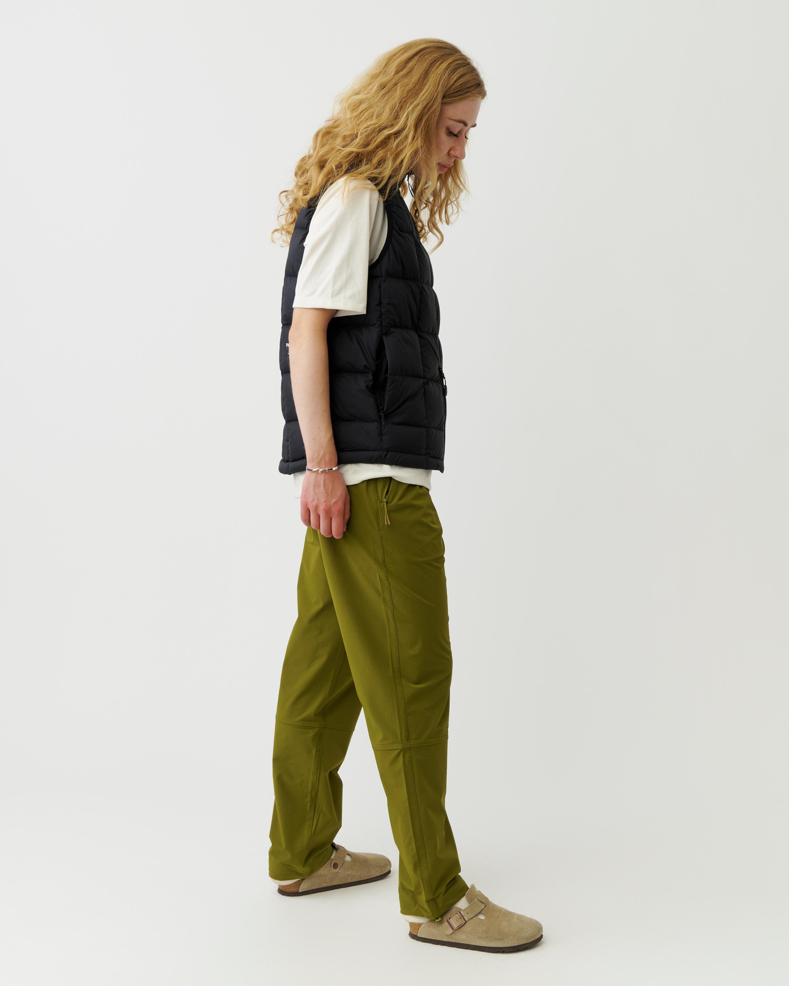 Black Off-Race Down Vest on model, side view with quilted panels and zip pocket