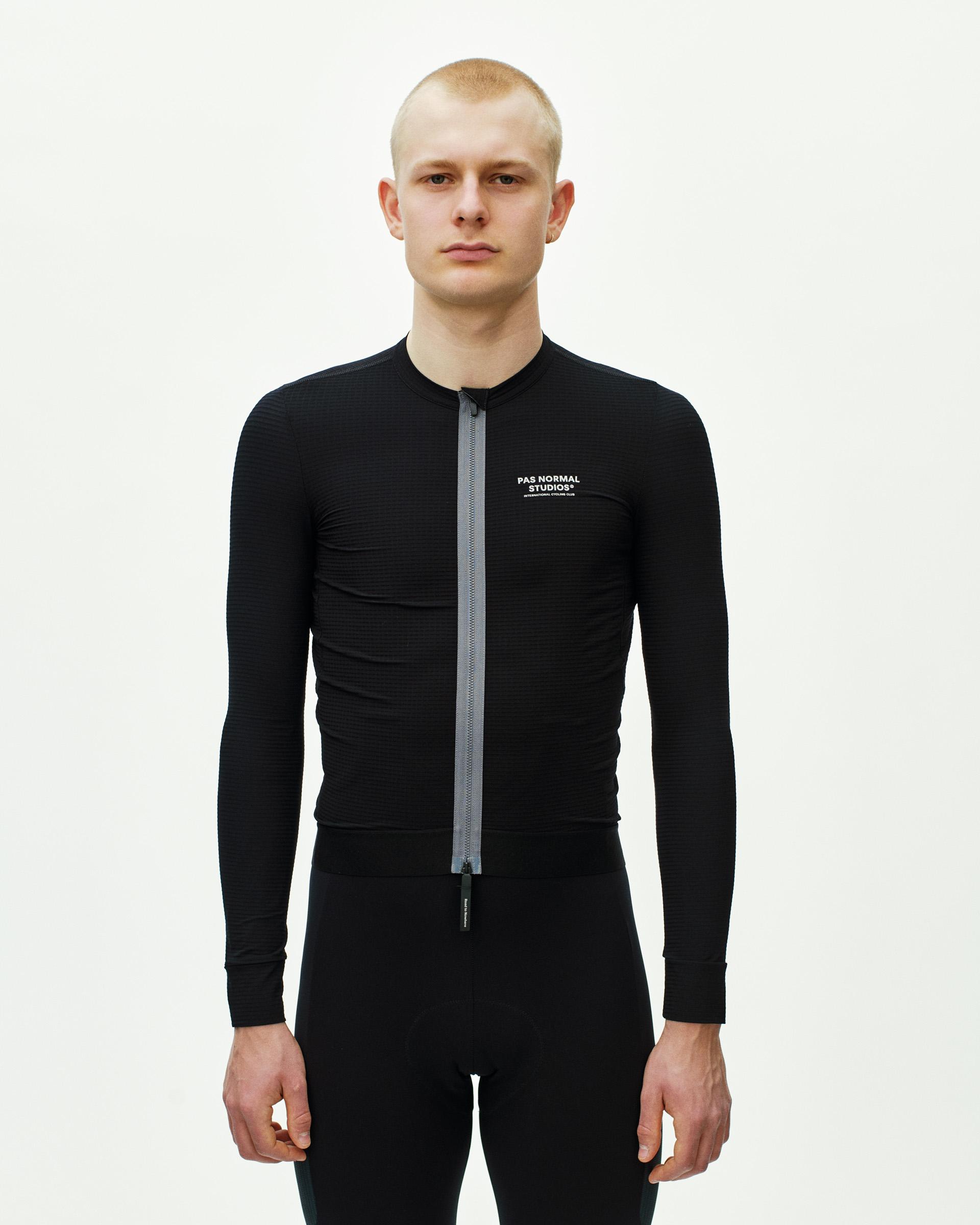 Black Escapism long sleeve cycling jersey on model with full front zip and chest logo