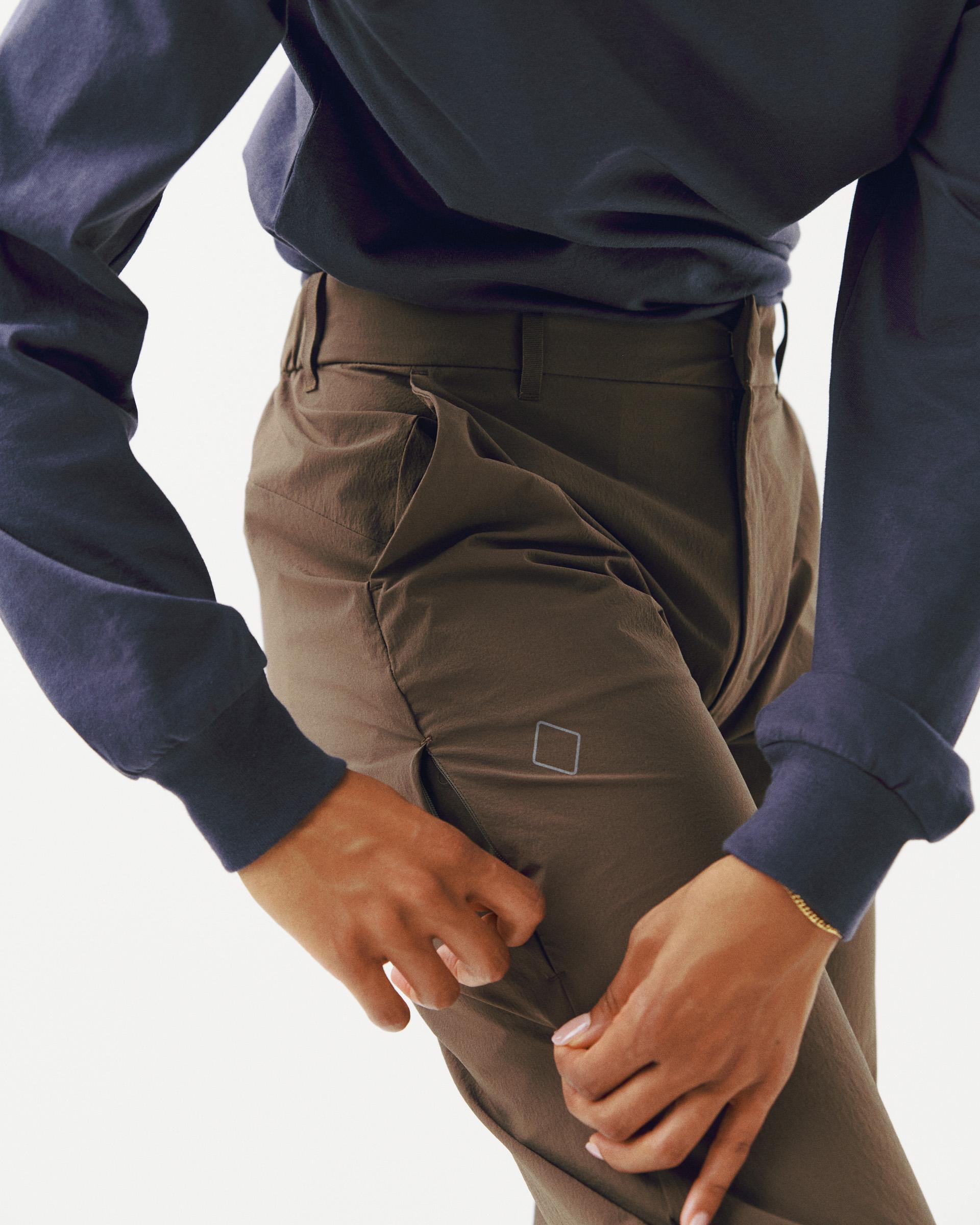 Brown Off-Race Tech pants on model showing cargo pocket and tapered fit