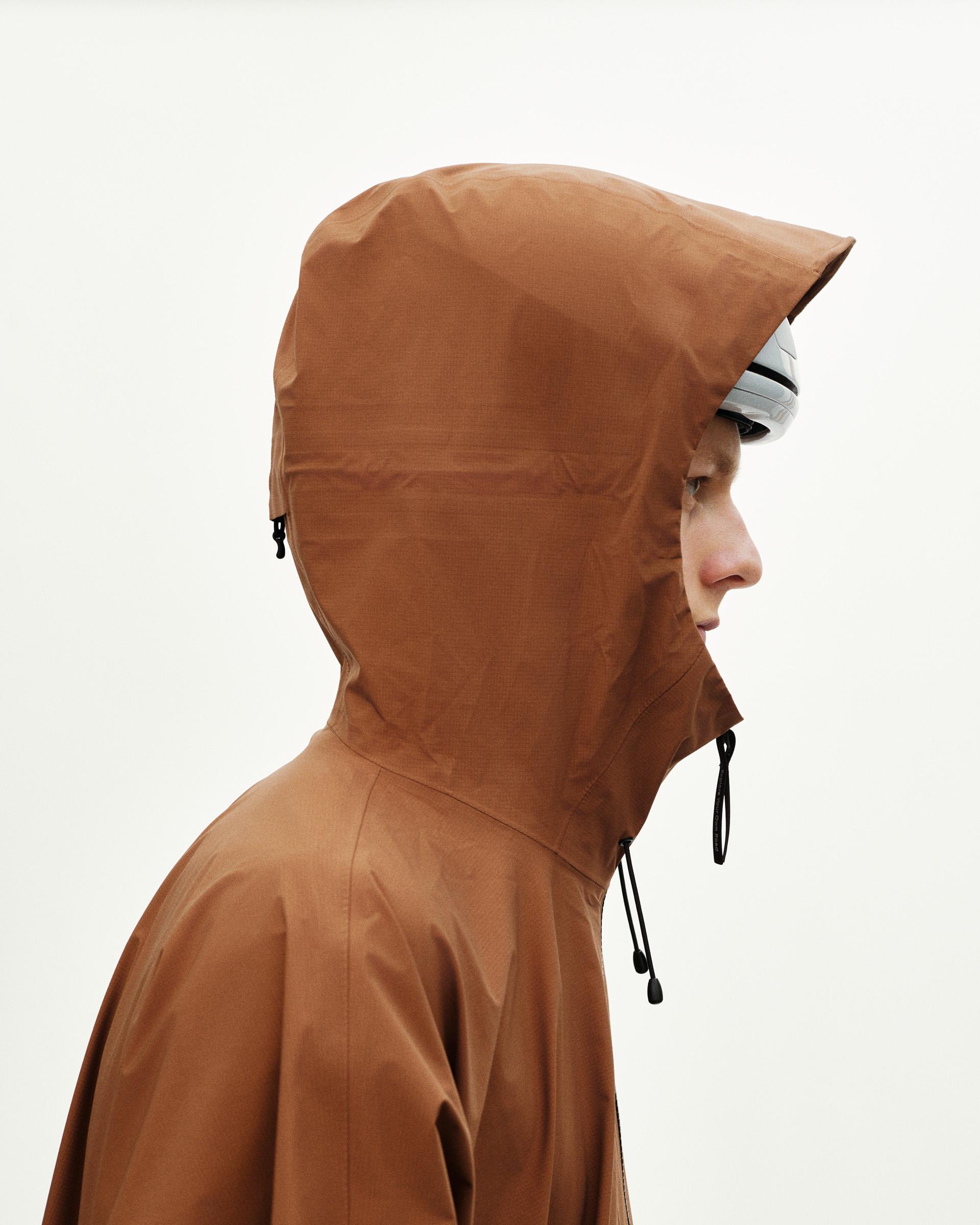 Brown Off-Race 3L Poncho on model, side view with adjustable hood and drawstrings