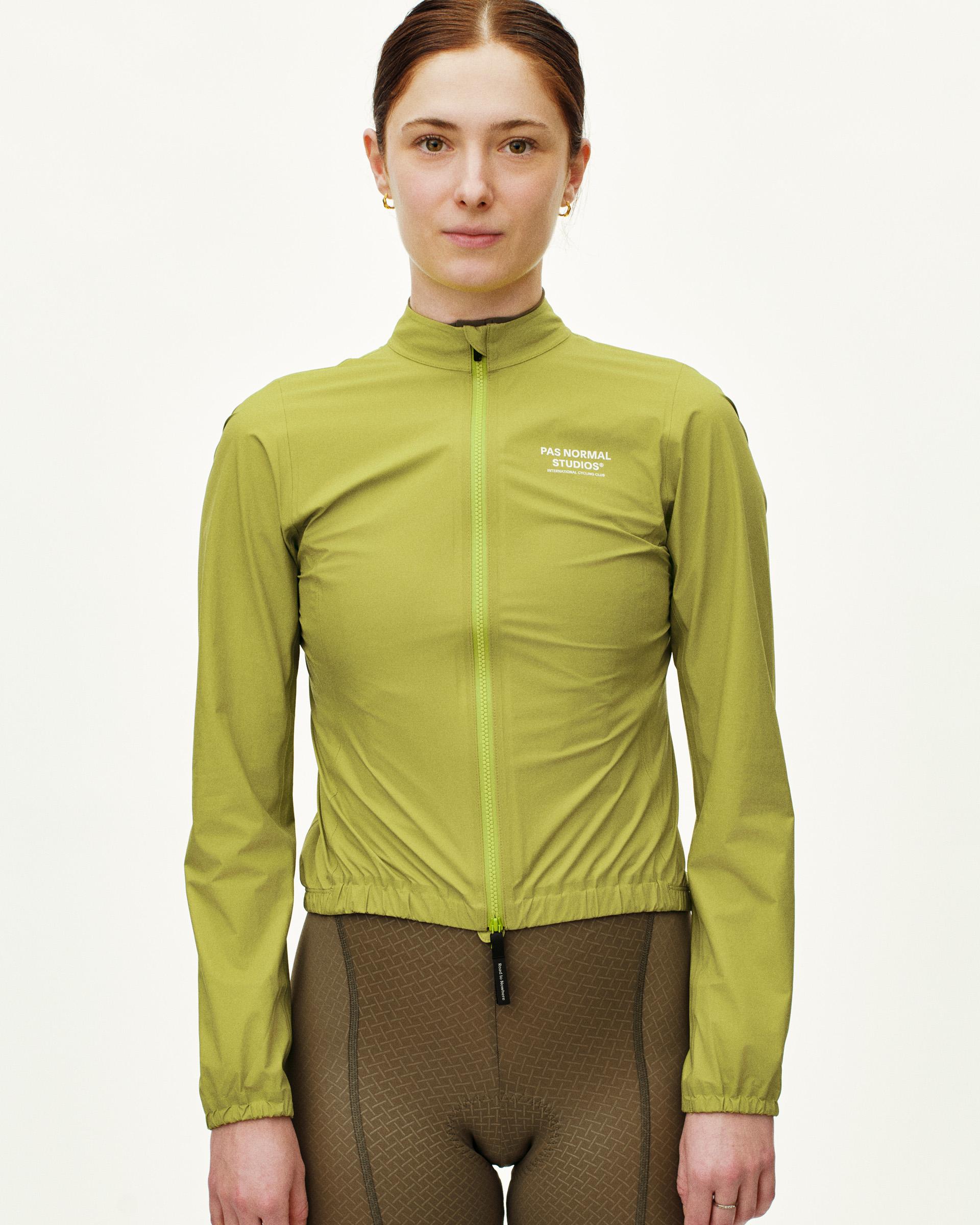 Green Mechanism Rain cycling jacket on model with elastic hem and contrast zip