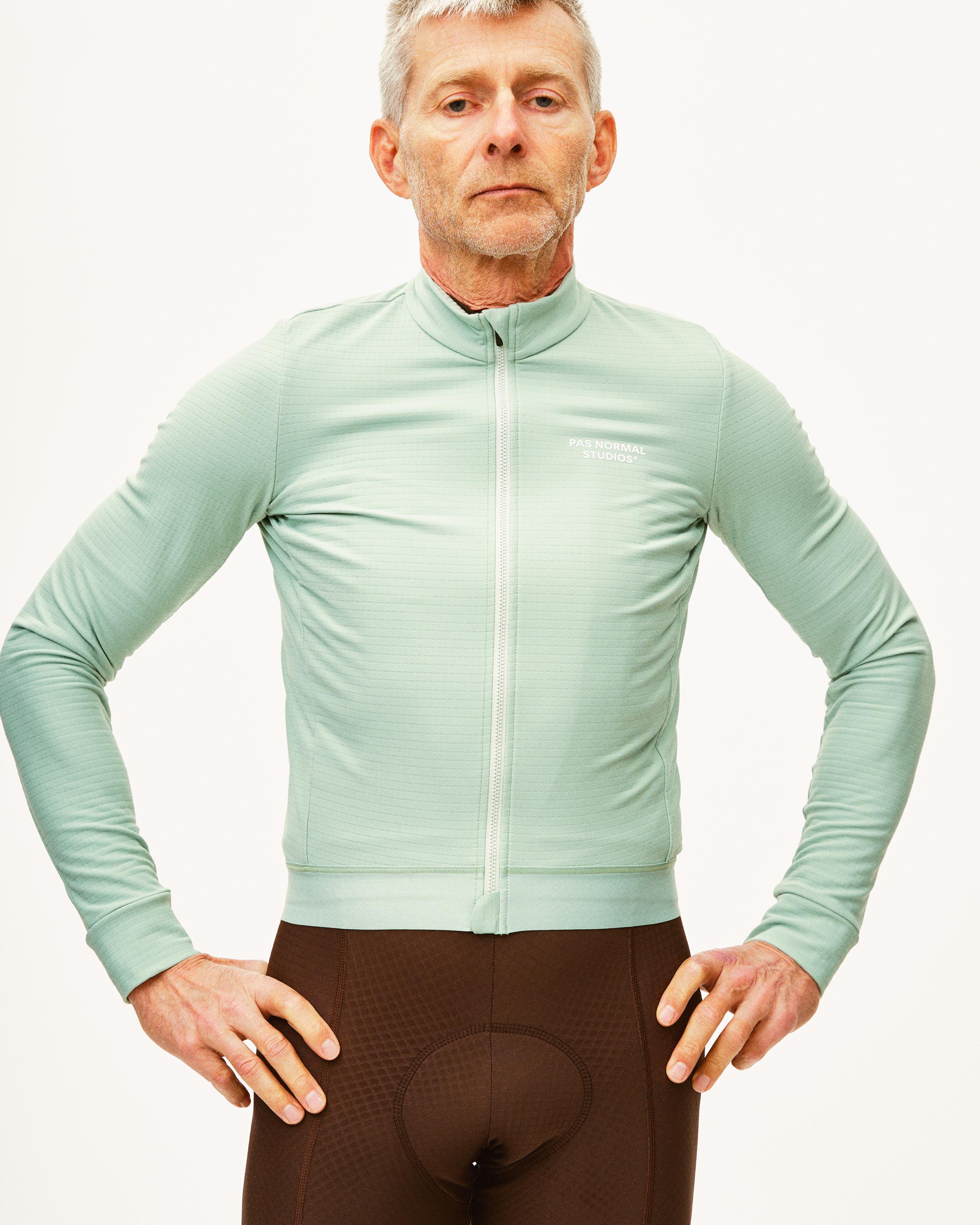 Green Essential long sleeve cycling jersey on model with full zip and white chest logo