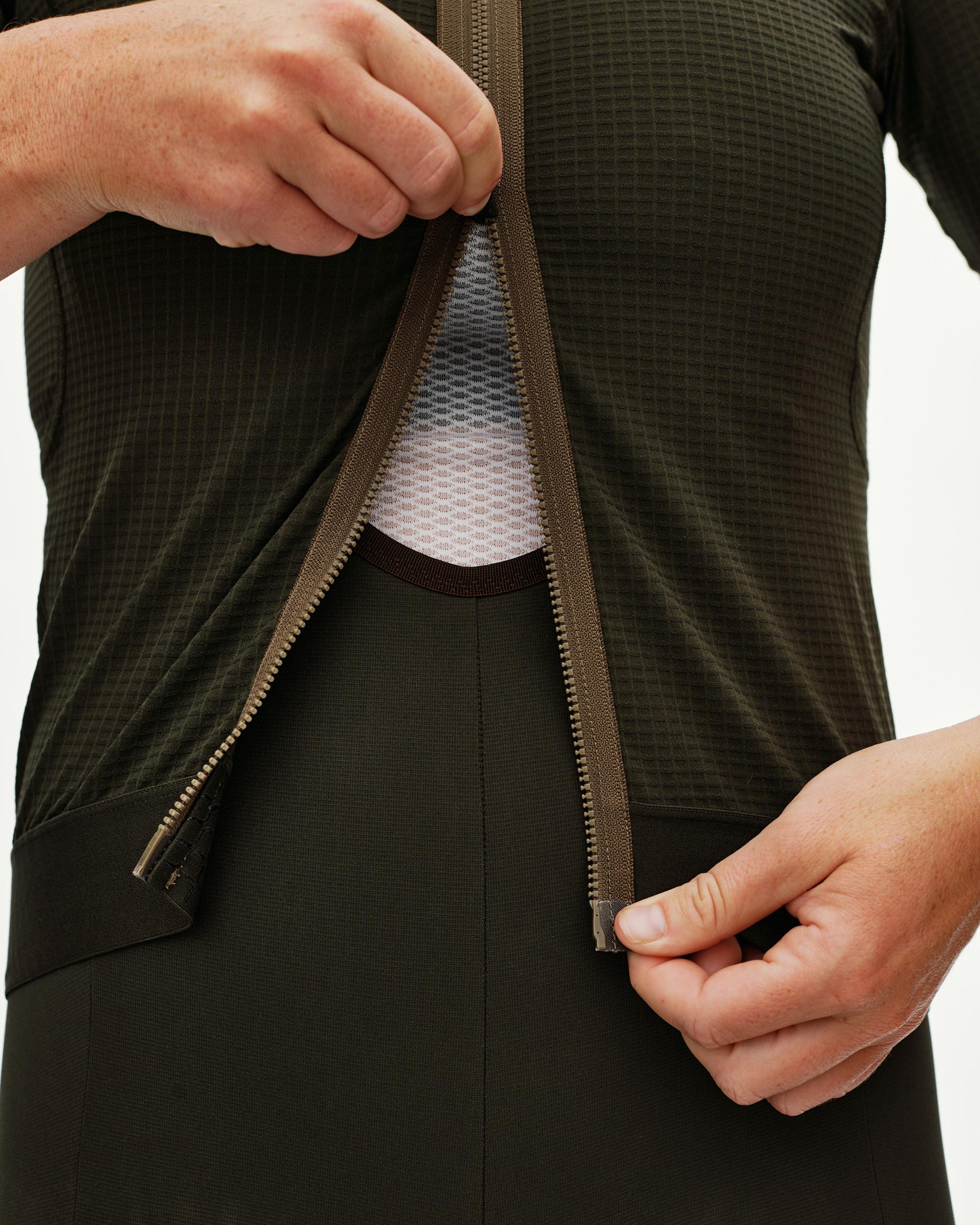 Dark Olive Escapism cycling jersey, detail view on model showing open front zip