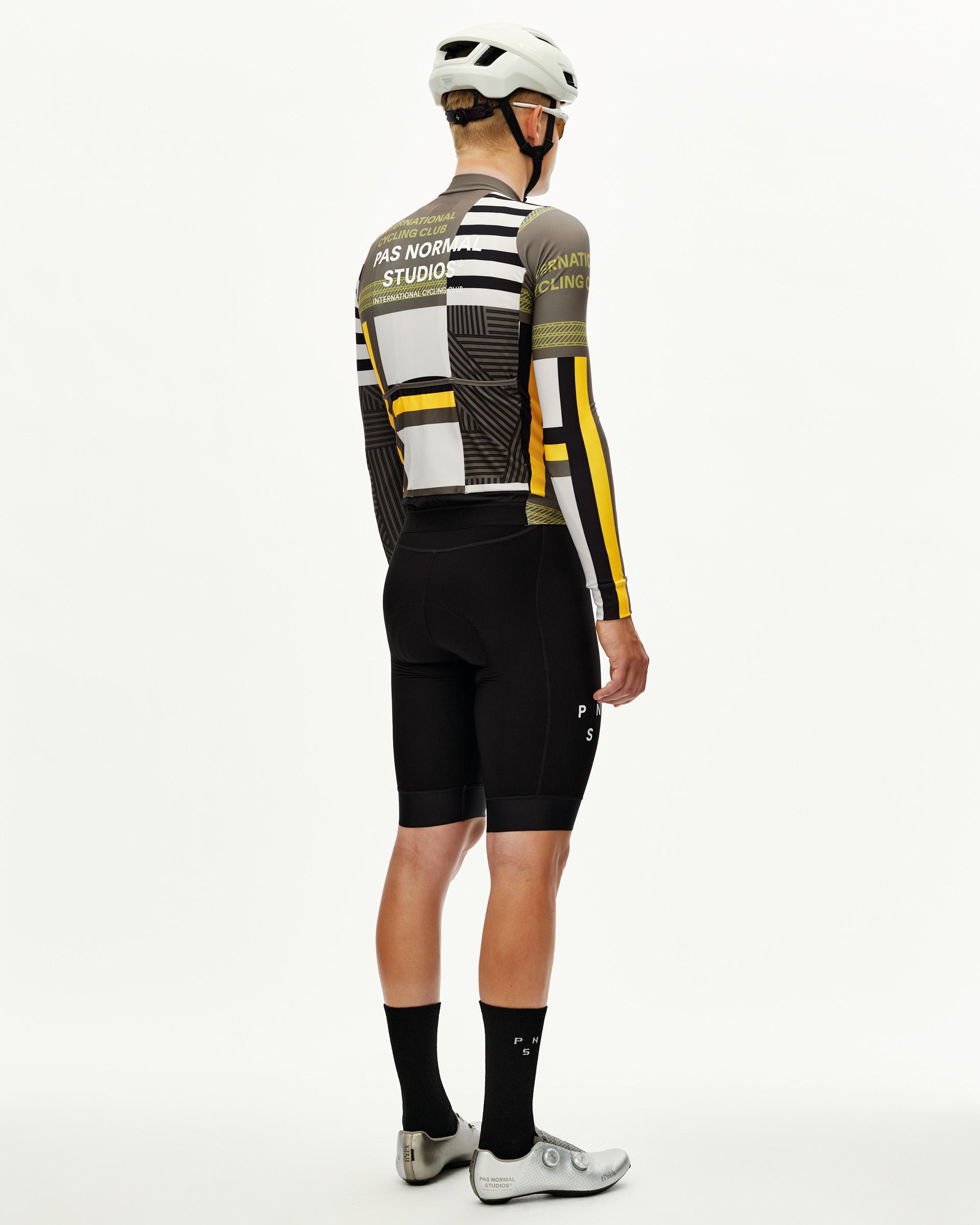 International Sand Mechanism long sleeve cycling jersey on model, rear view with geometric multicolour block print