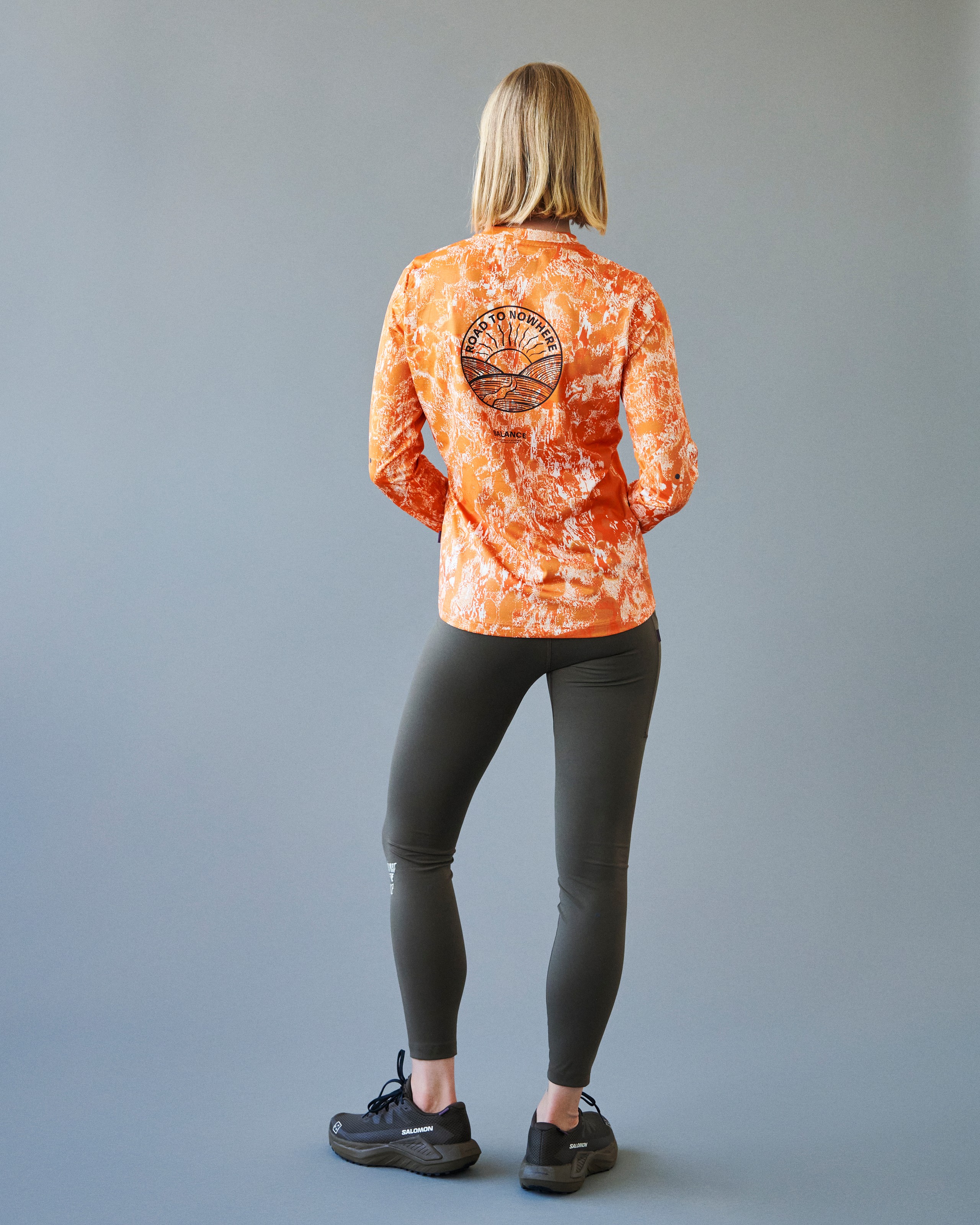 Orange Balance long sleeve t-shirt on model, rear view with black back print