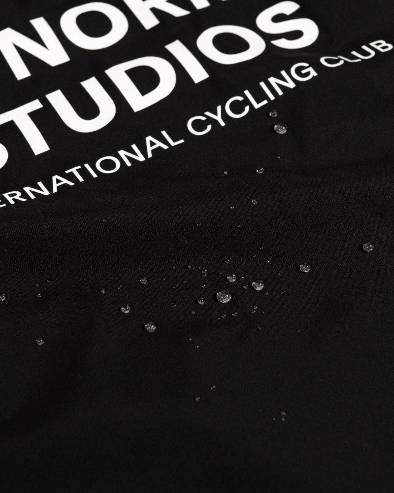 Black Mechanism Stow Away gilet detail view showing water-repellent fabric with beaded droplets