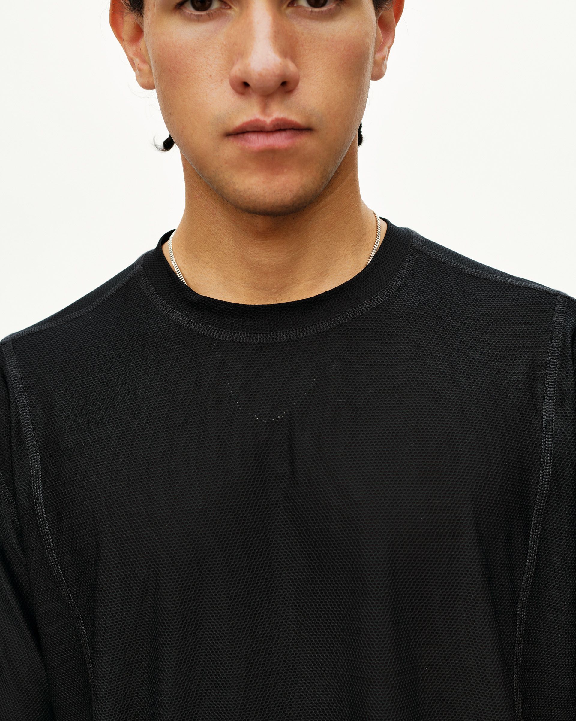 Black Balance T-shirt on model, front detail view with tonal logo and textured fabric
