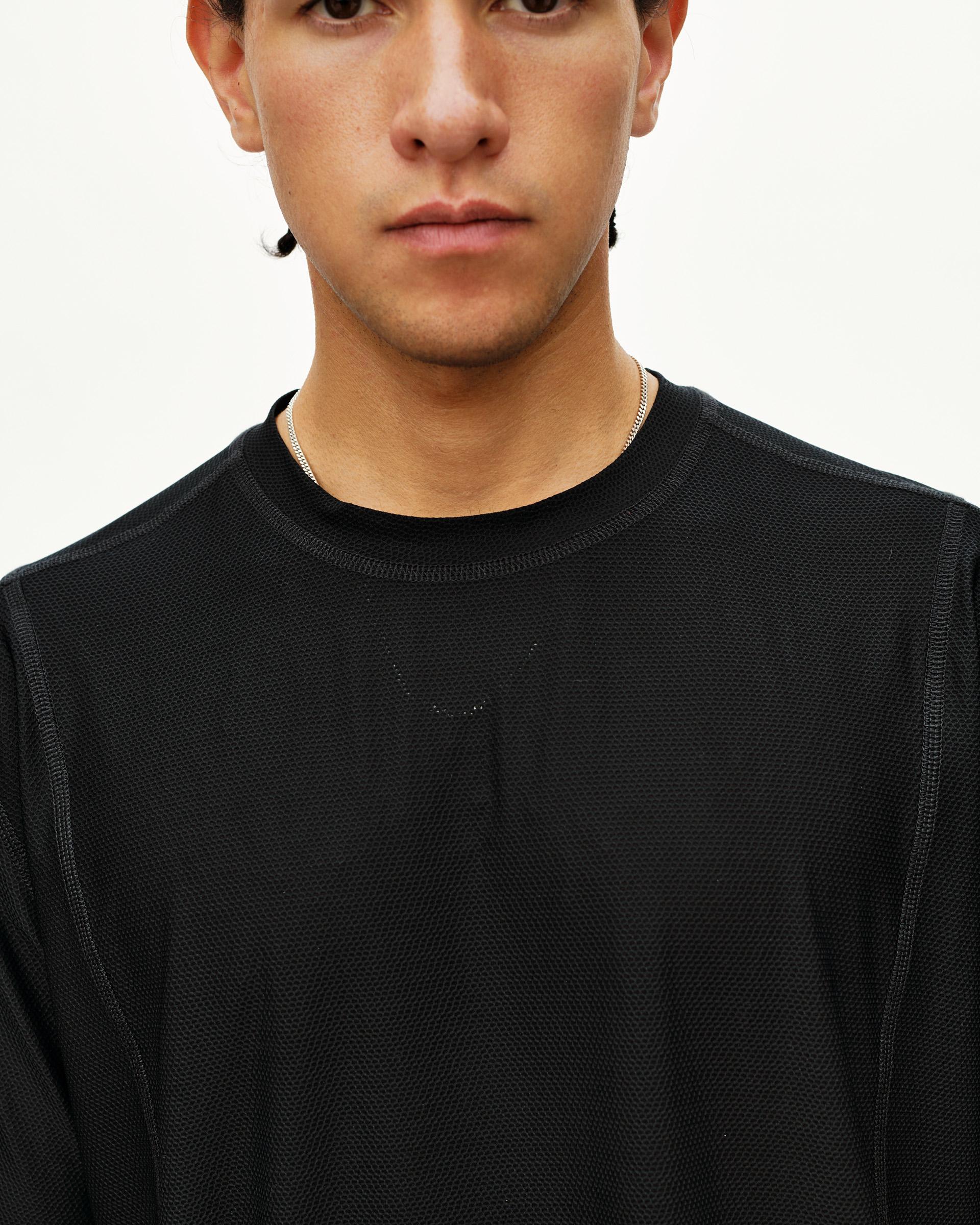 Black Balance T-shirt on model, front detail view with tonal logo and textured fabric