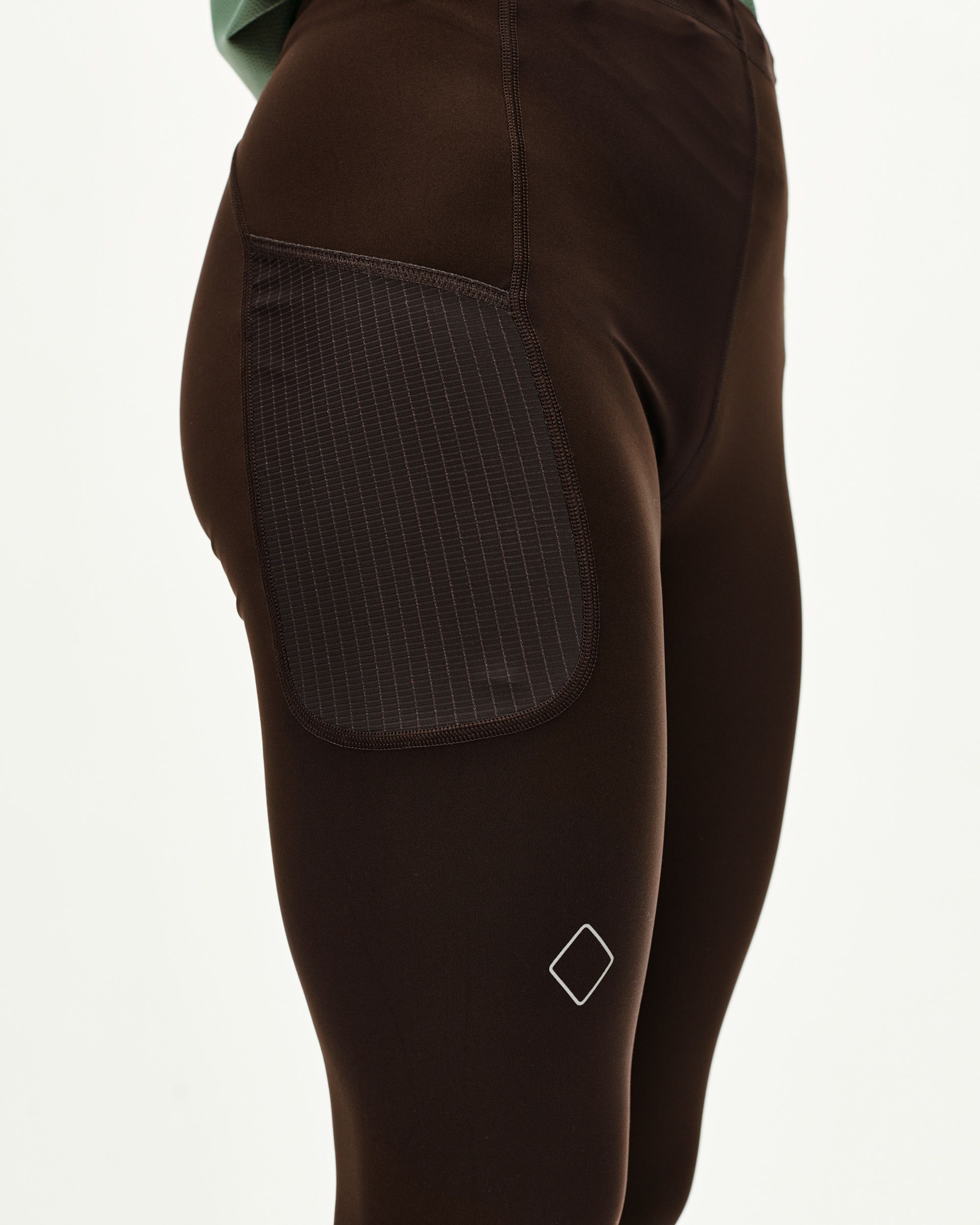 Dark Coffee brown Balance women's long tights, side detail on model with contrast ripstop thigh pocket