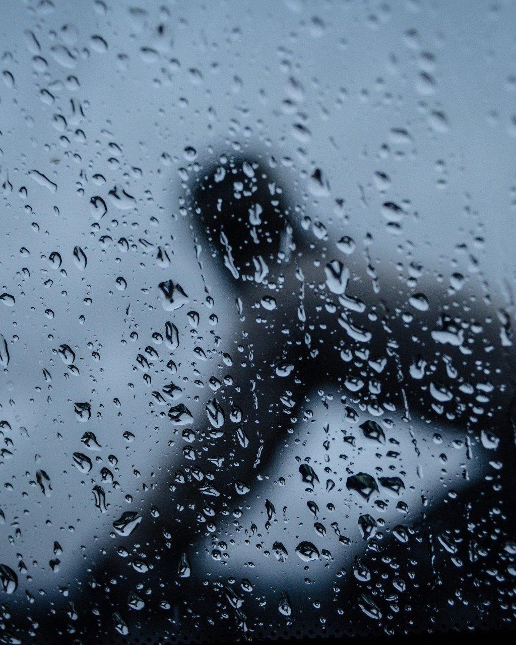 Cyclist in rain with water droplets on glass or helmet visor
