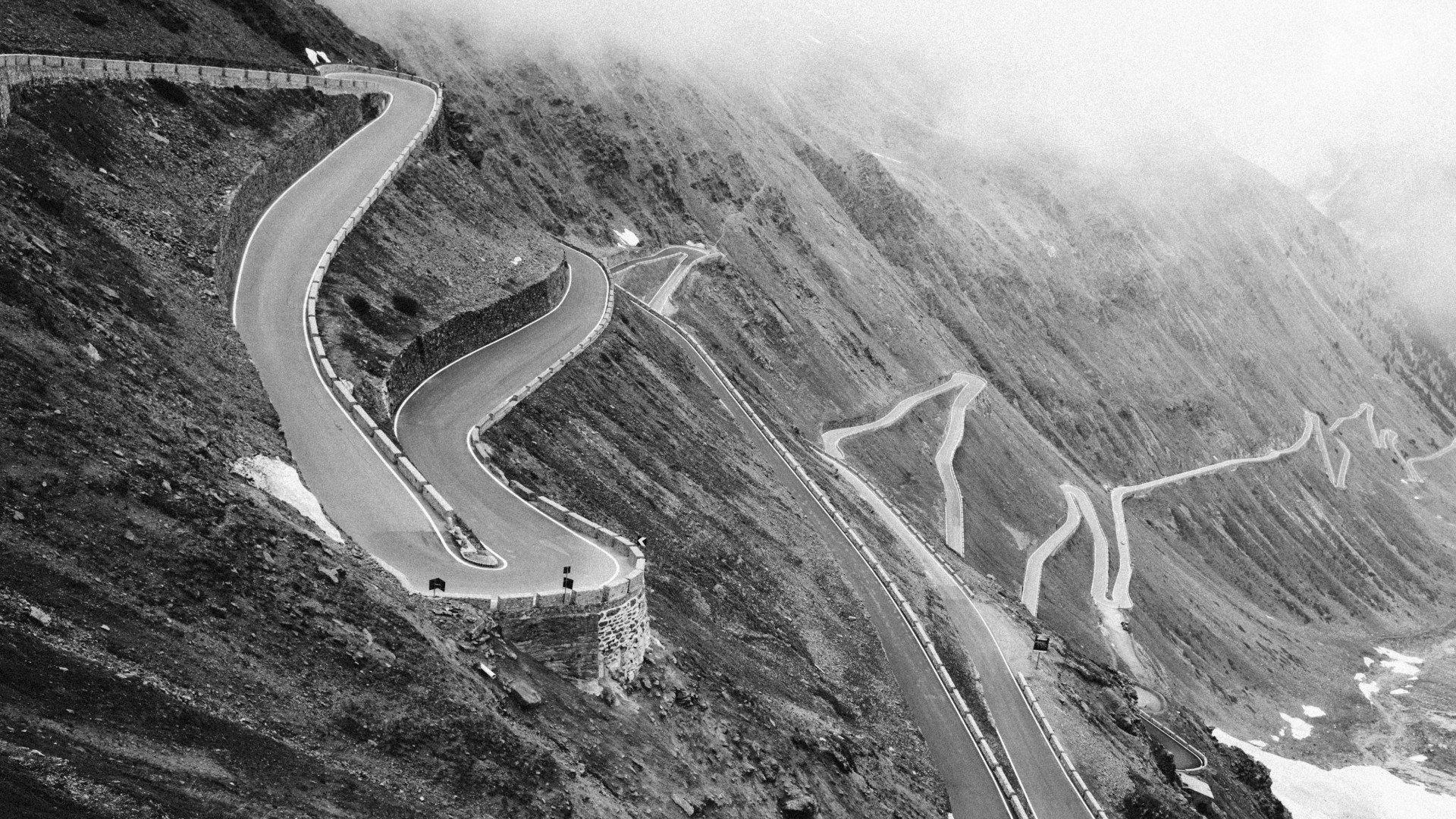 Winding mountain road with switchback turns in black and white