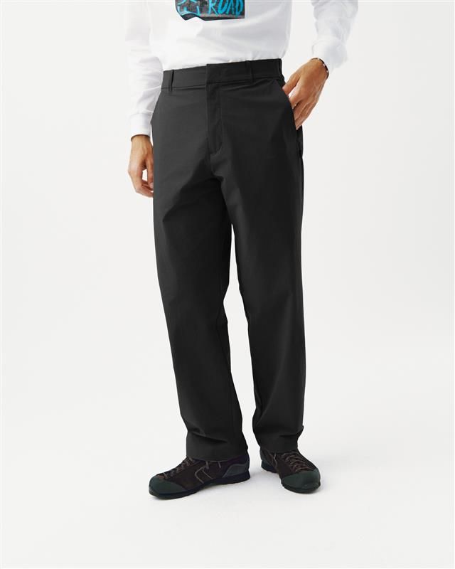 Black Off-Race Tech pants on model, front three-quarter view with side pockets