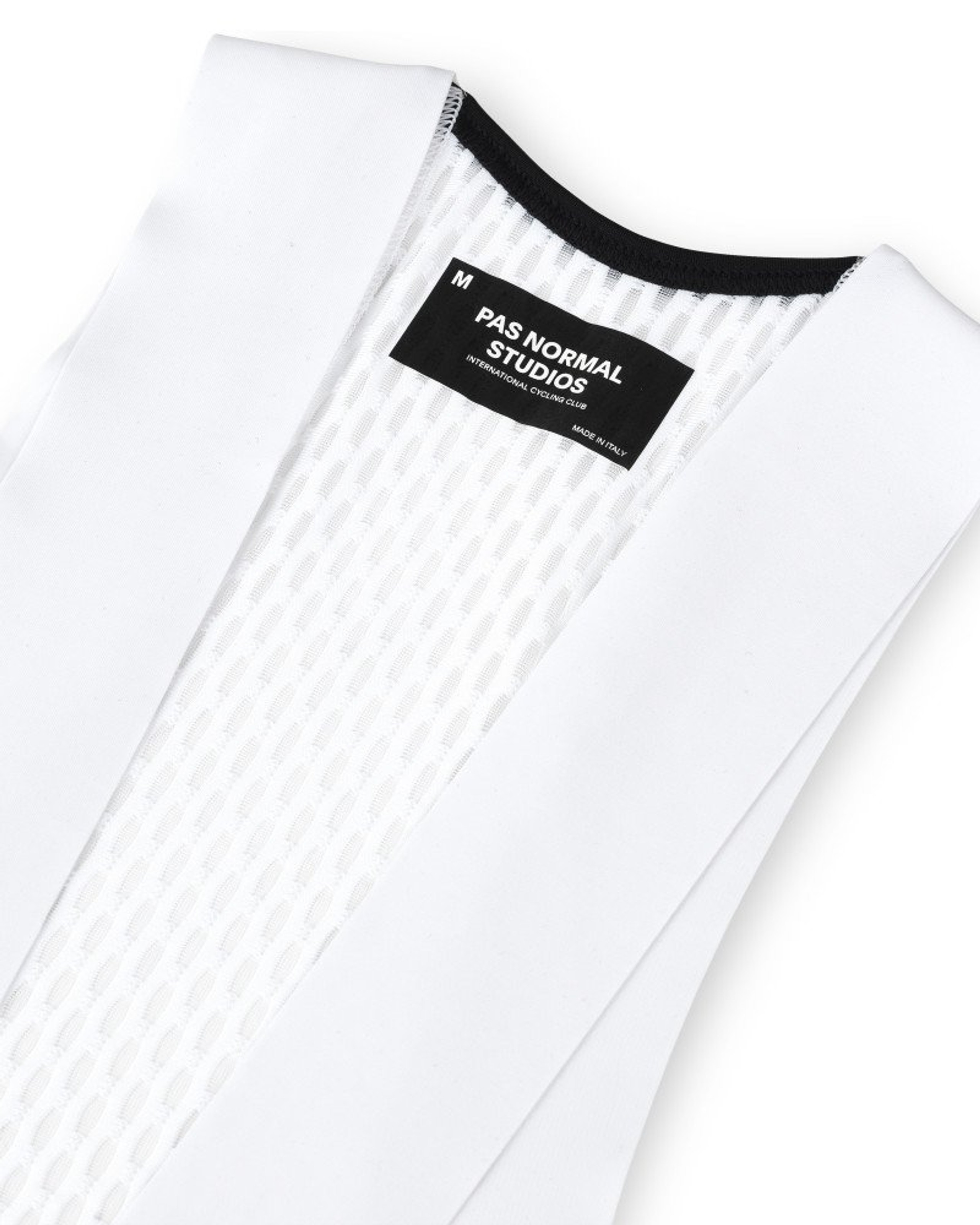 White Mechanism bibs, flat lay showing black waistband and internal label