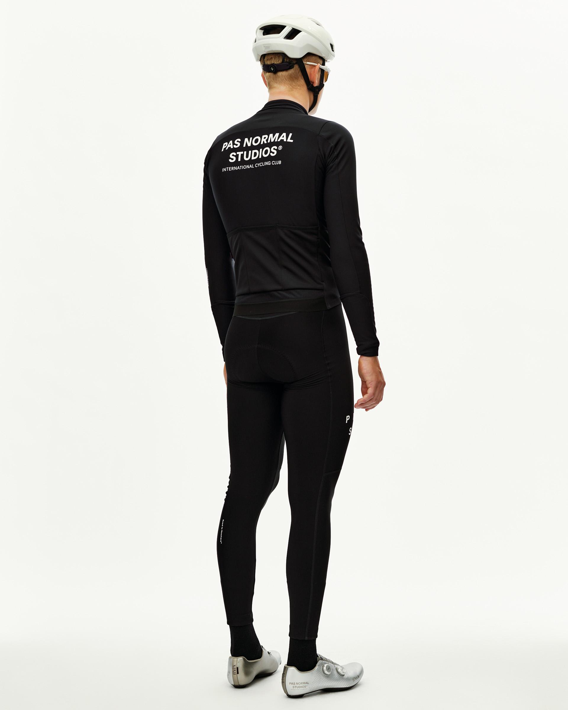 Black Mechanism Thermal Long Sleeve Jersey 2.0 cycling jersey on model, rear view with white back print