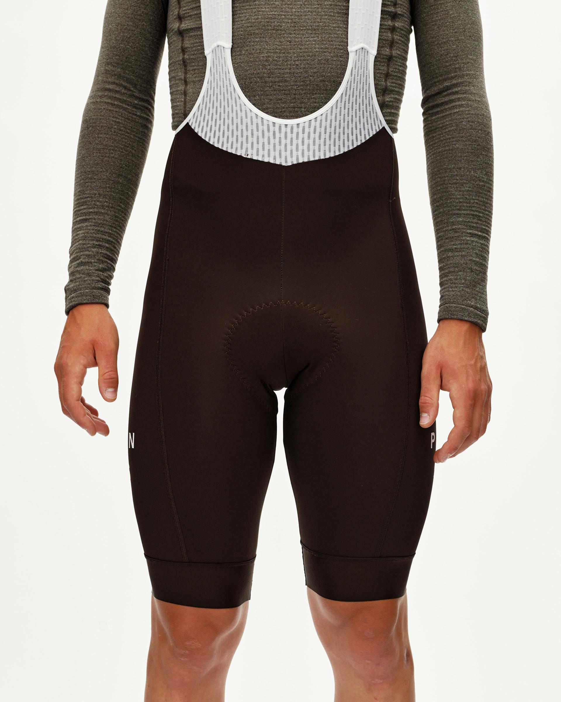 Dark Coffee brown Mechanism cycling bibs on model, front view with white mesh bib panel