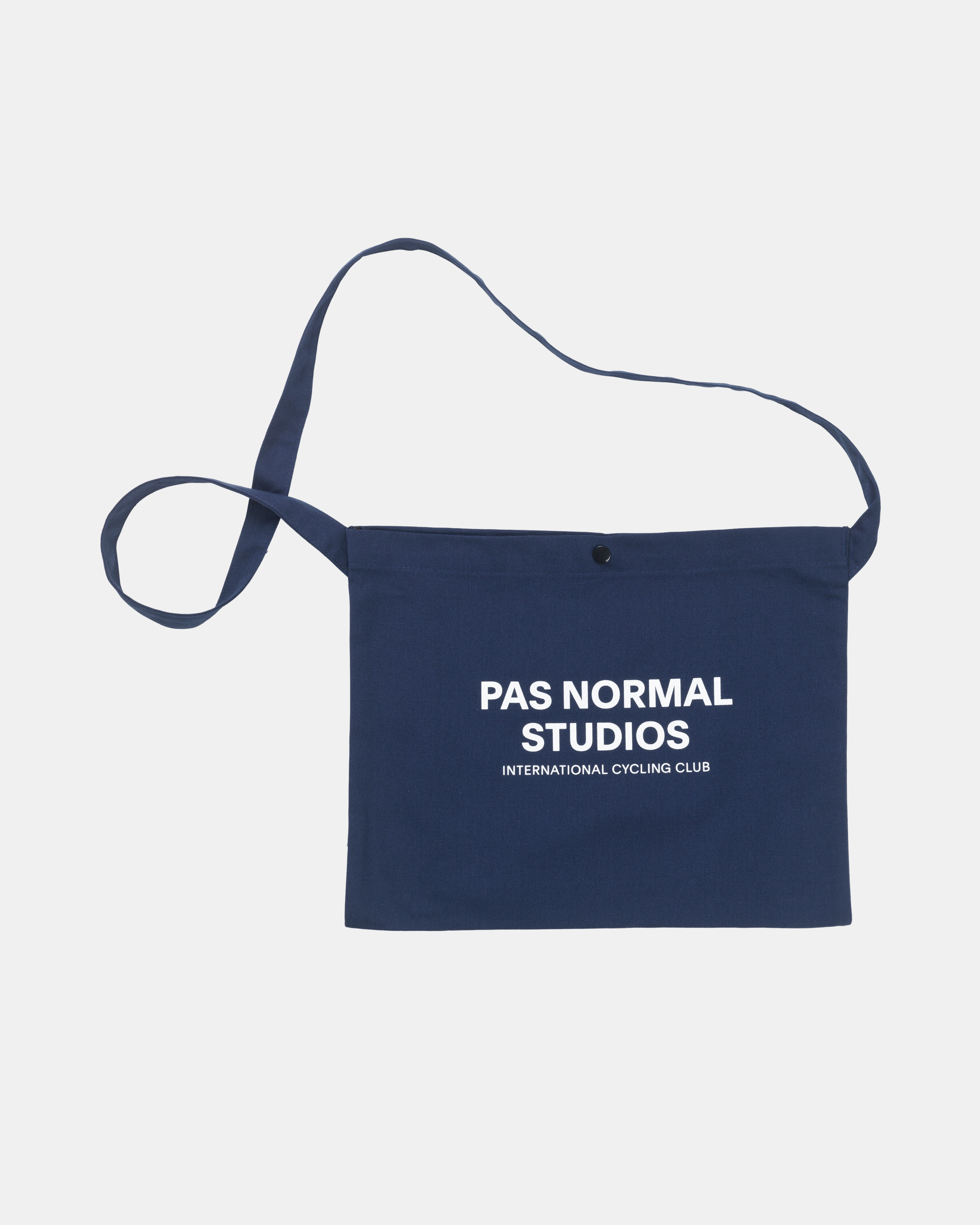 Navy Off-Race musette, front flat lay with white logo print and snap closure