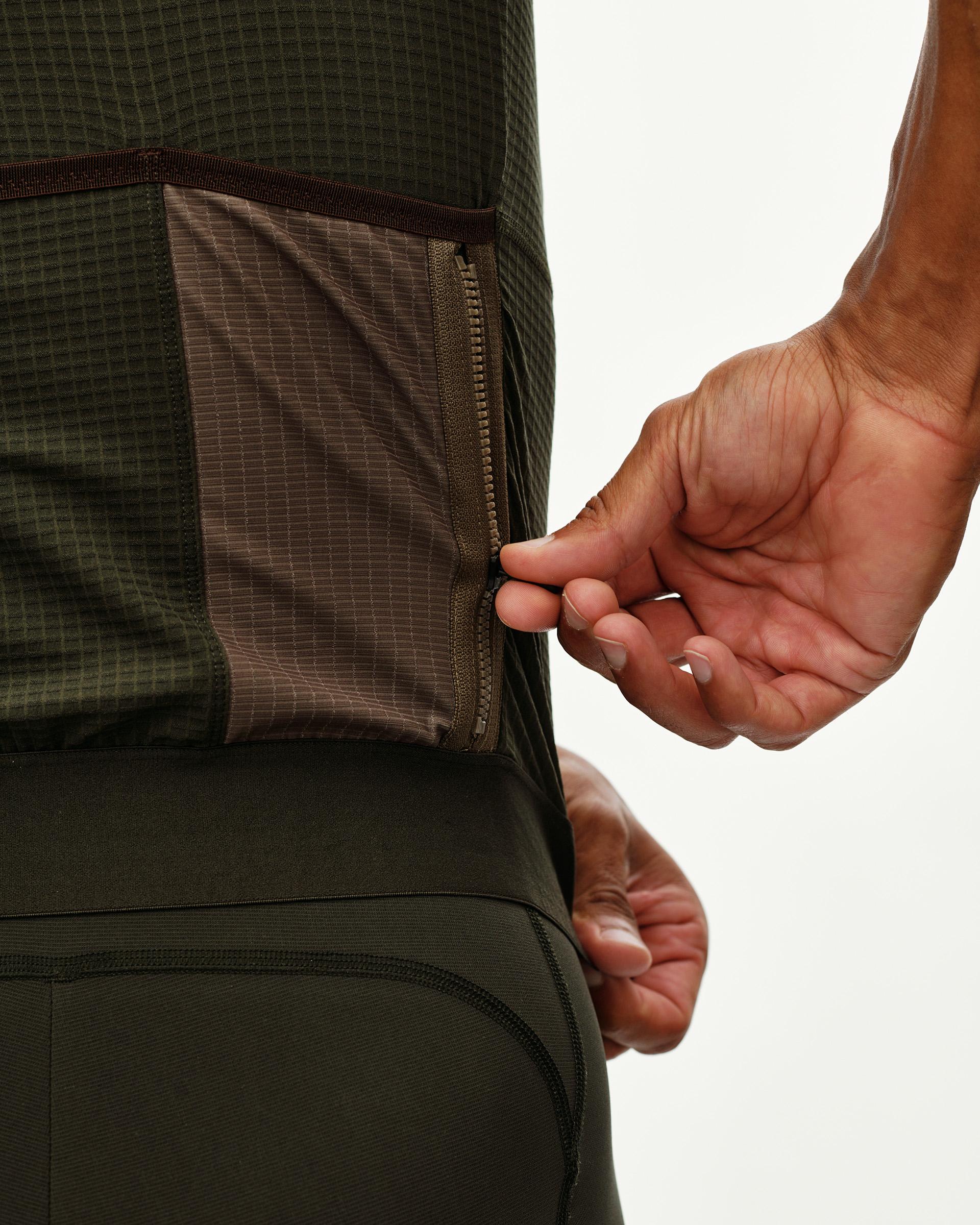 Dark Olive Escapism cycling jersey, rear detail on model showing zipped side pocket