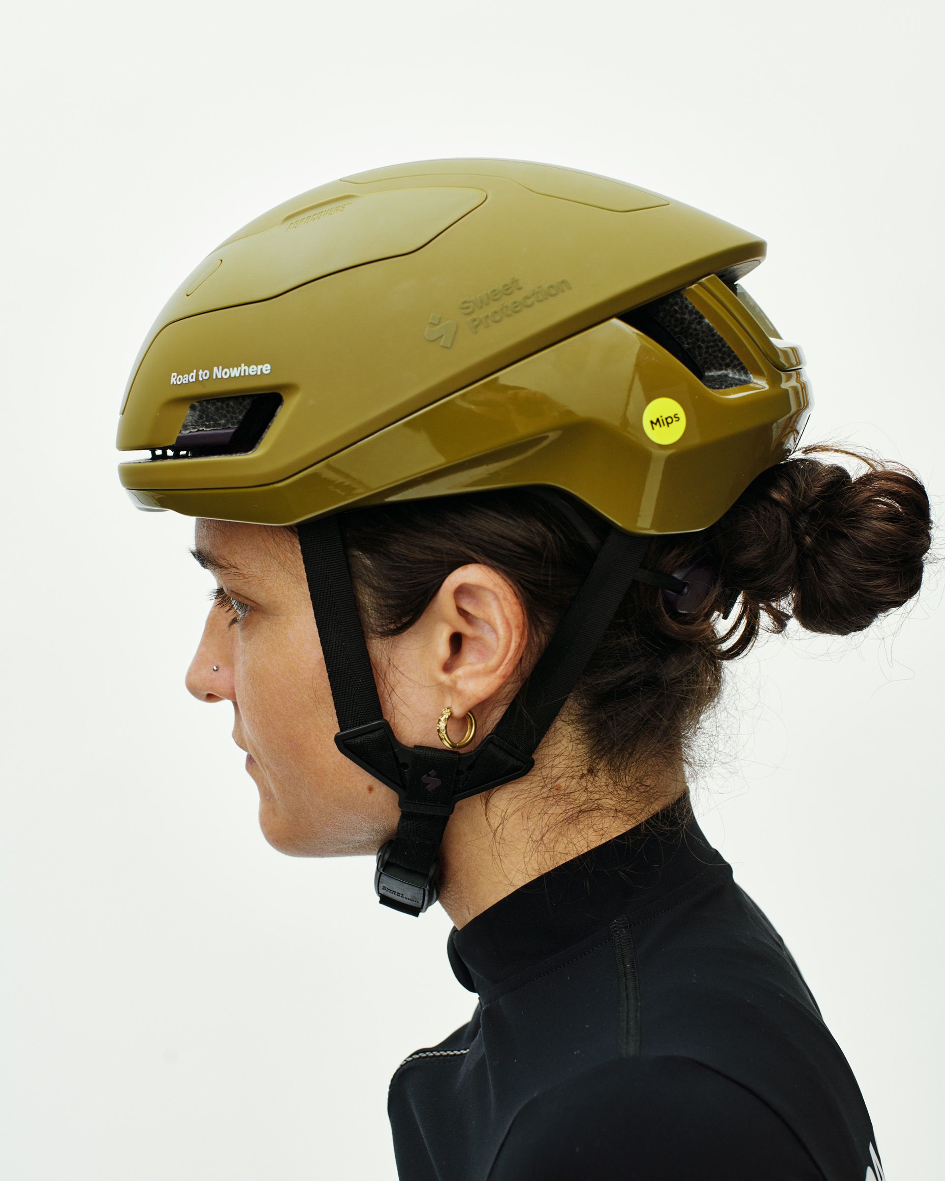 Yellow Sweet Protection Falconer Aero2Vi cycling helmet on model, side view with aerodynamic venting