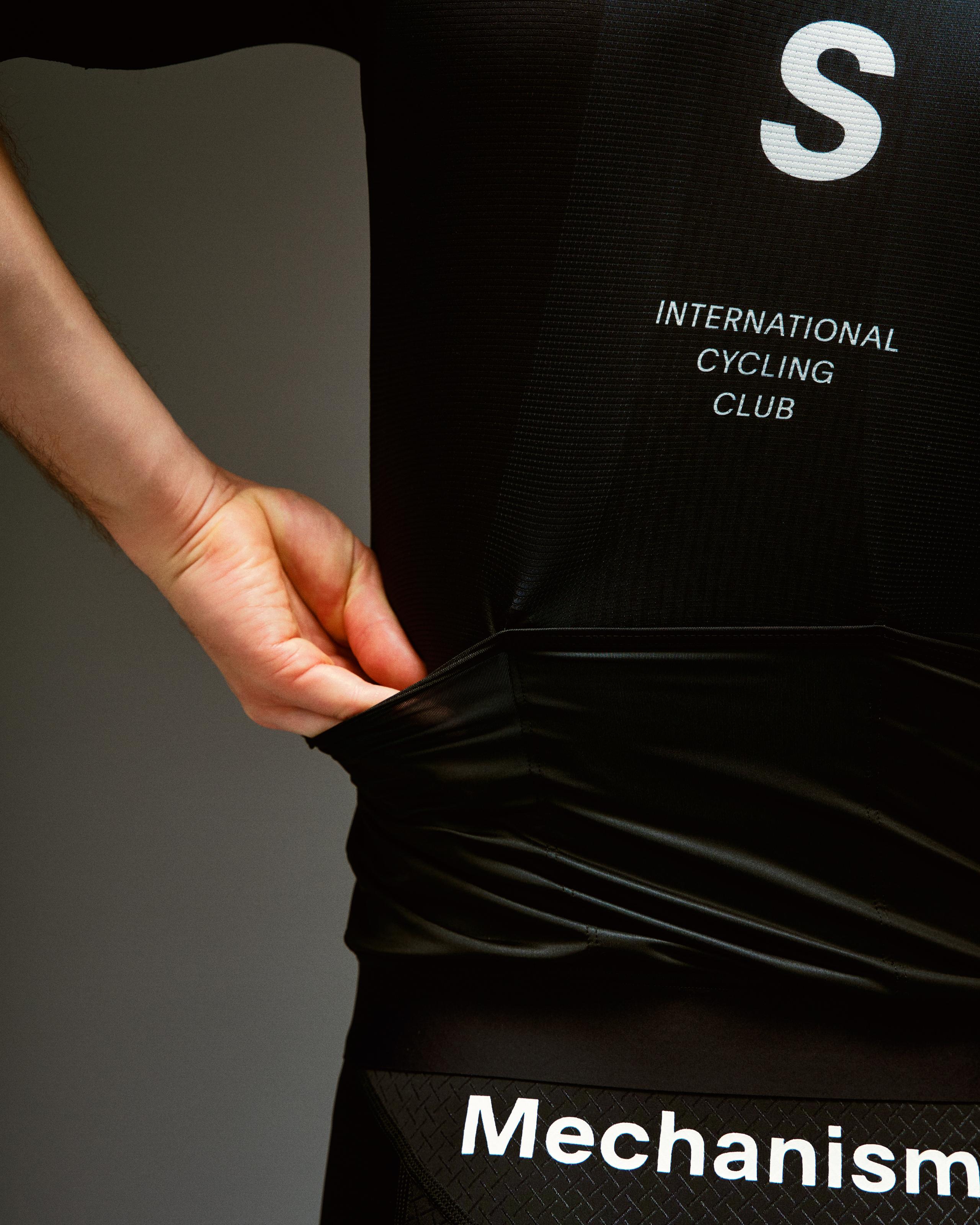 Black Mechanism cycling jersey on model with white International Cycling Club chest print