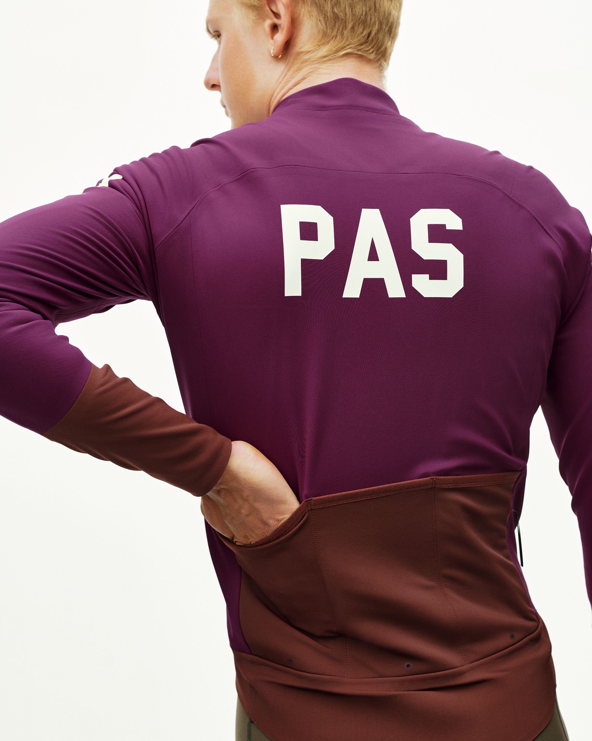 Dark Purple Mechanism Thermal cycling jacket on model, rear view with white back print and contrast dark brown lower panel