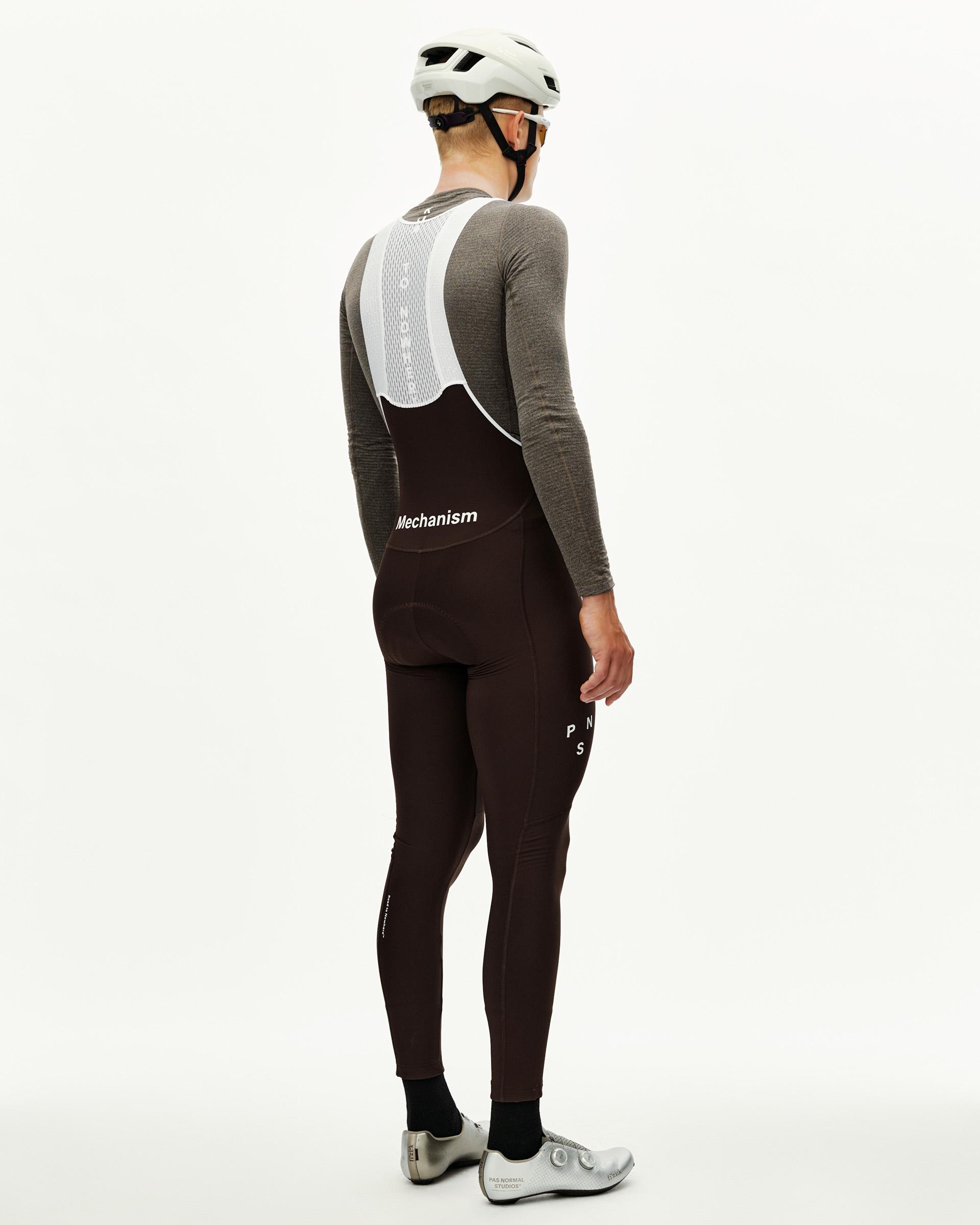 Dark Coffee Mechanism Thermal Long cycling bibs on model, rear view with white mesh bib straps