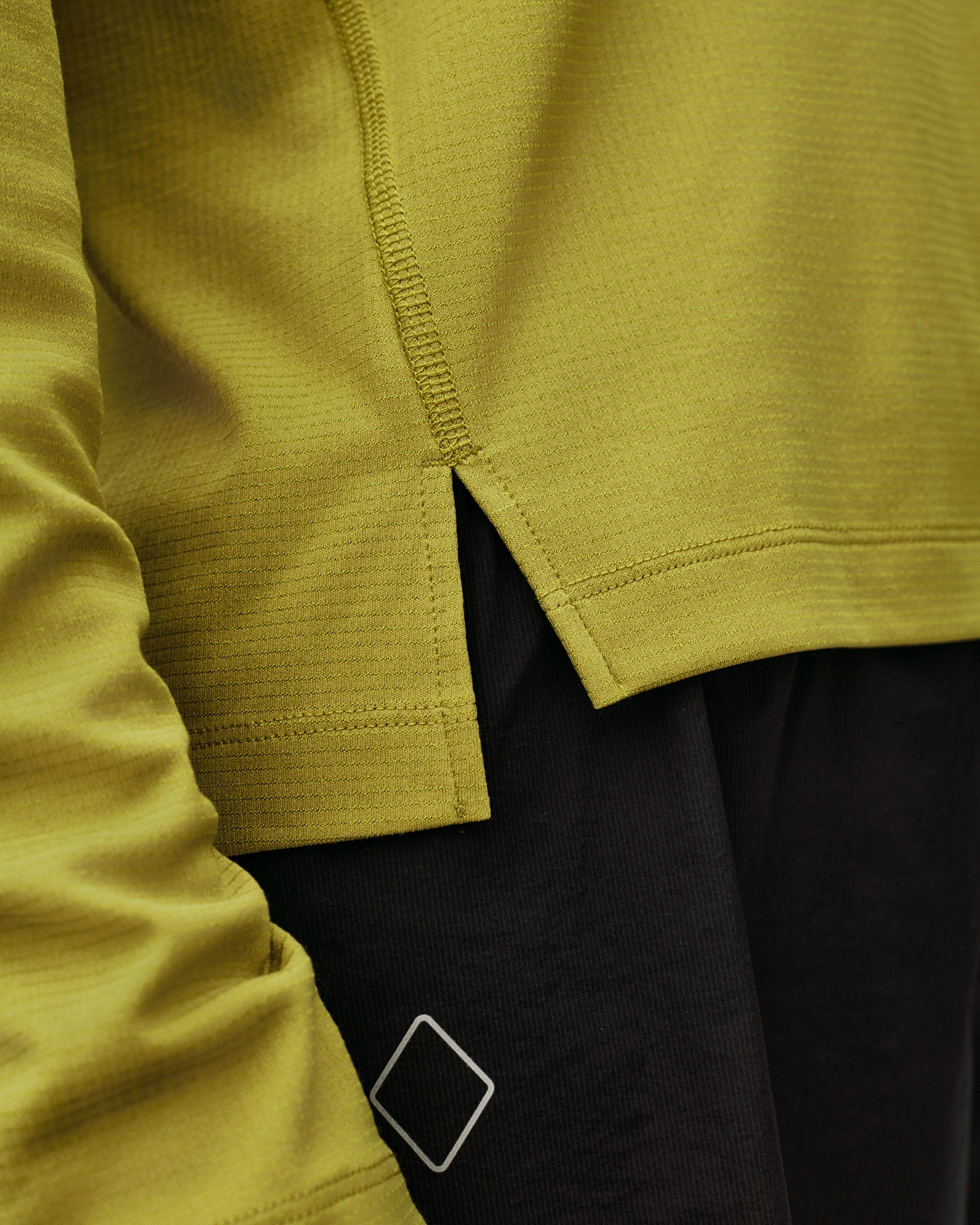 Dark Lime green Balance women's long sleeve T-shirt, detail view showing hem vent and side zip